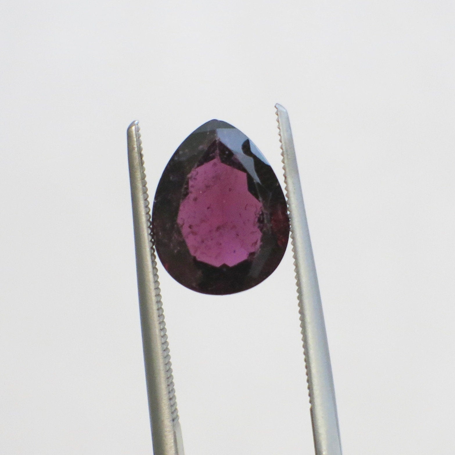 2.93 Carat pear cut Rhodolite Garnet loose gemstone in purplish-red, 10x8mm, showcasing its vibrant color and elegant shape.