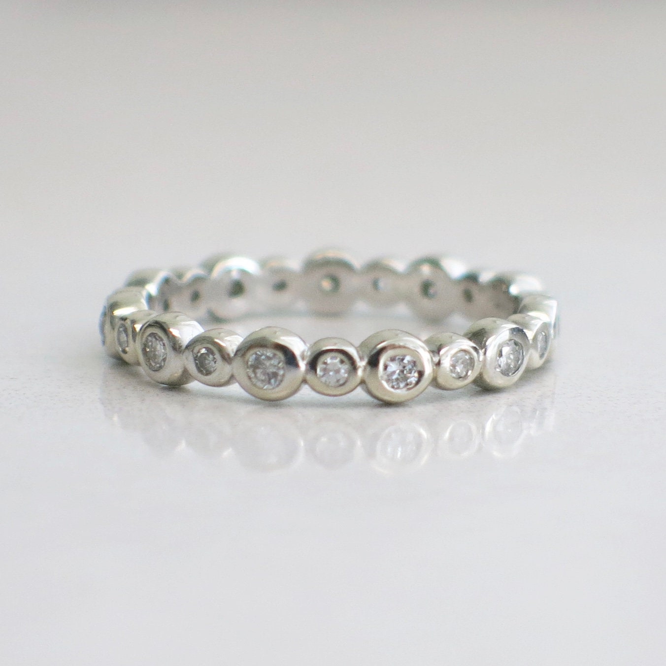 14K white gold diamond bezel eternity band ring with sparkling diamonds, size 5.5, from Black Market LLC.