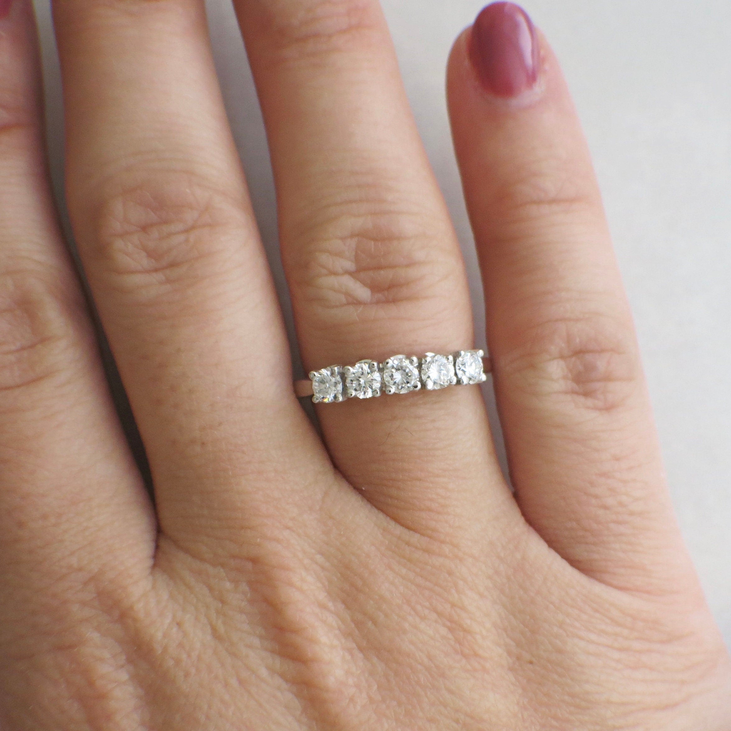 14K white gold five-stone diamond anniversary ring with 0.70 CTW, SI1 F clarity, size 7, featuring sparkling diamonds.