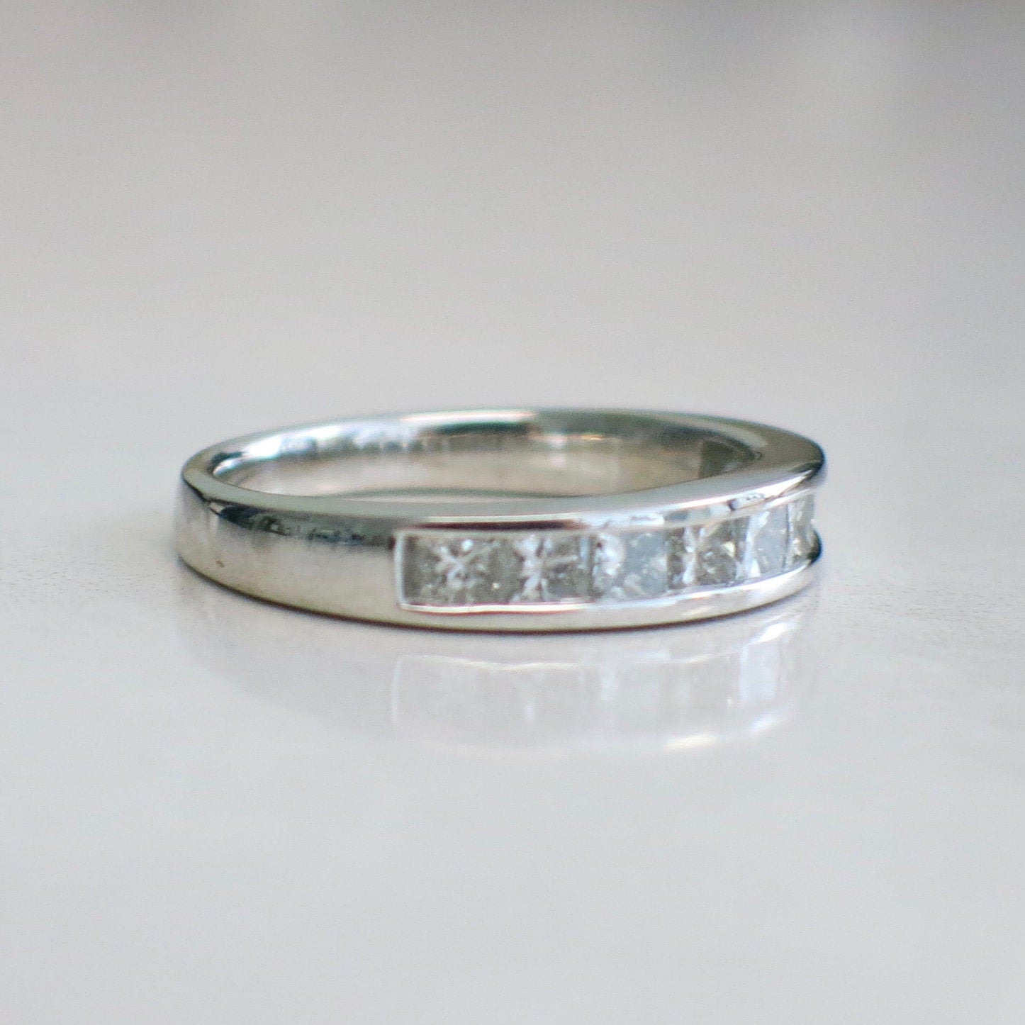 14K white gold princess cut diamond band with channel set diamonds, .90 CTW wedding ring in size 6.75 by Black Market LLC.