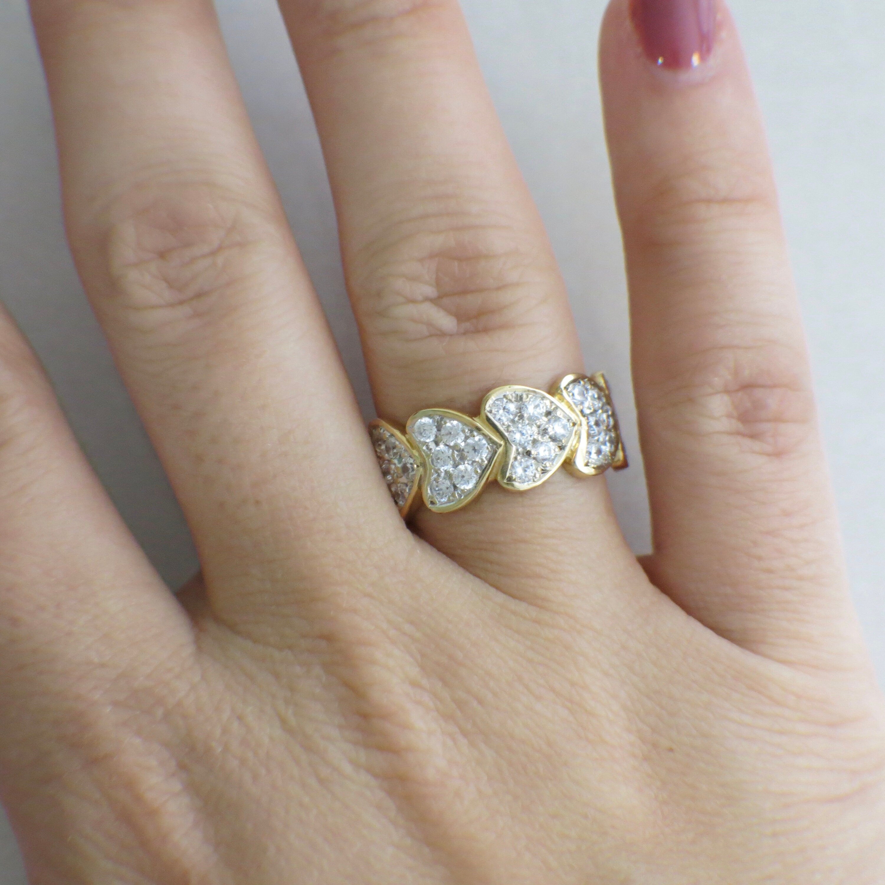 14K yellow gold pavé diamond heart ring with stacking hearts design, featuring 0.75 carats of sparkling diamonds.