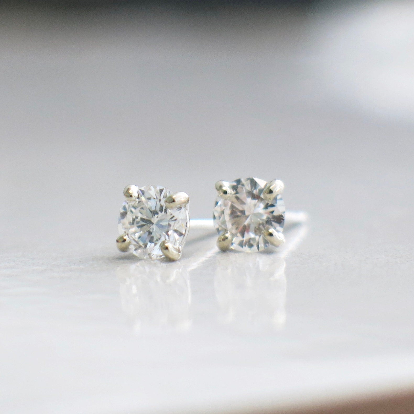 Diamond stud earrings in 14K white gold featuring 0.80 CT diamonds, four-prong setting, SI1 I–J clarity, by Black Market LLC.
