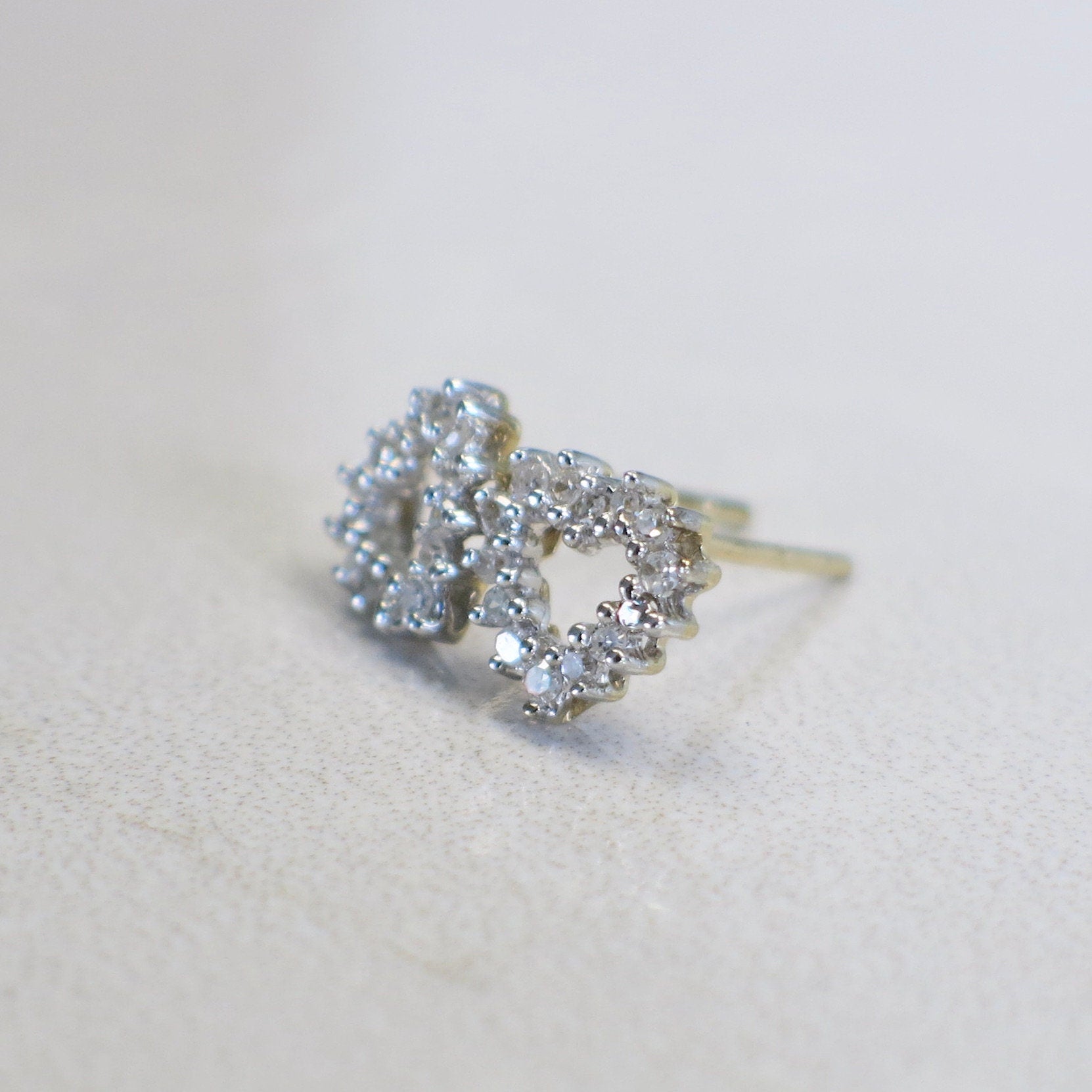 14K gold diamond open heart earrings by Black Market LLC featuring two-tone white and yellow gold stud design.