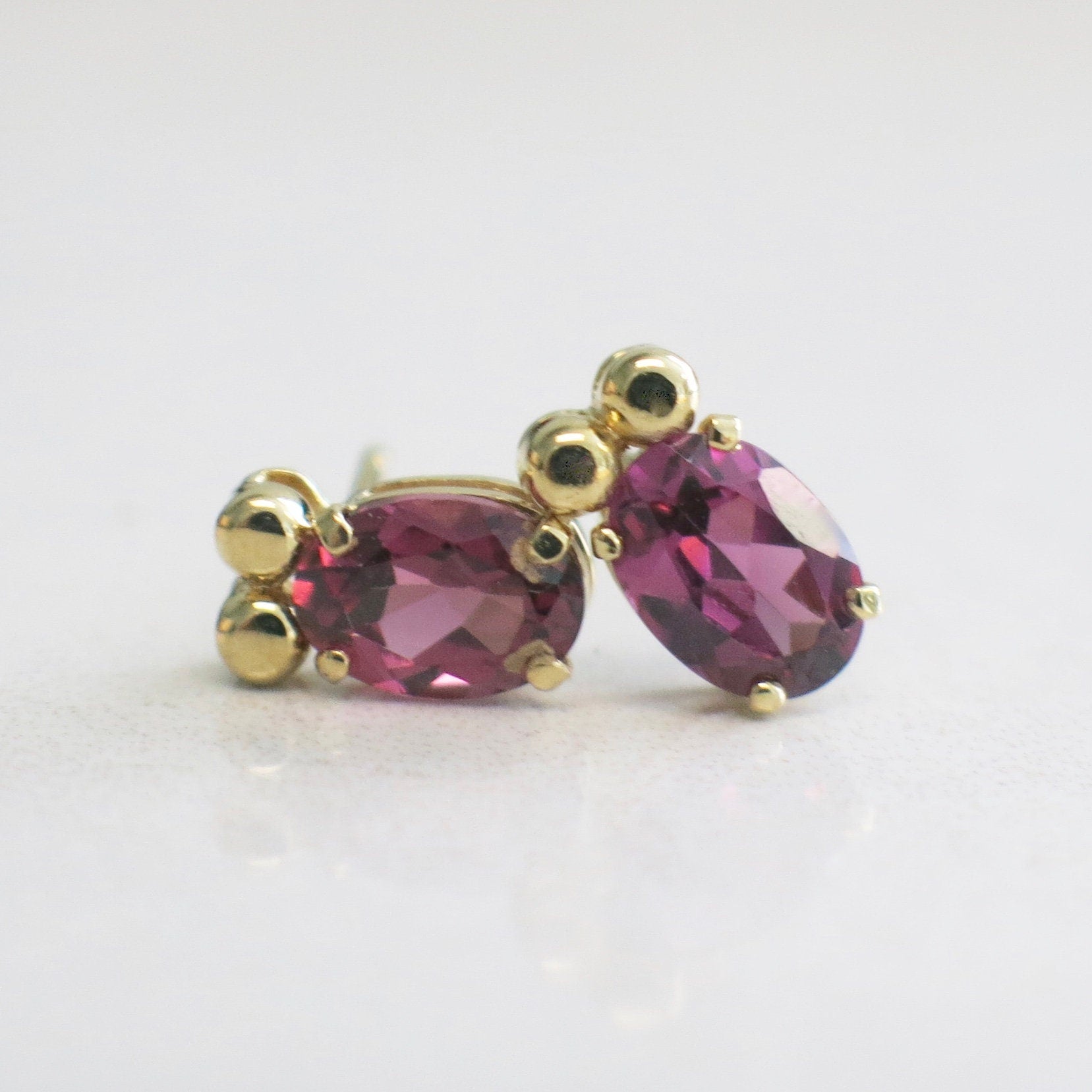 14K yellow gold Rhodolite Garnet earrings with oval 7x5mm garnet studs, elegant fine jewelry from Black Market LLC.
