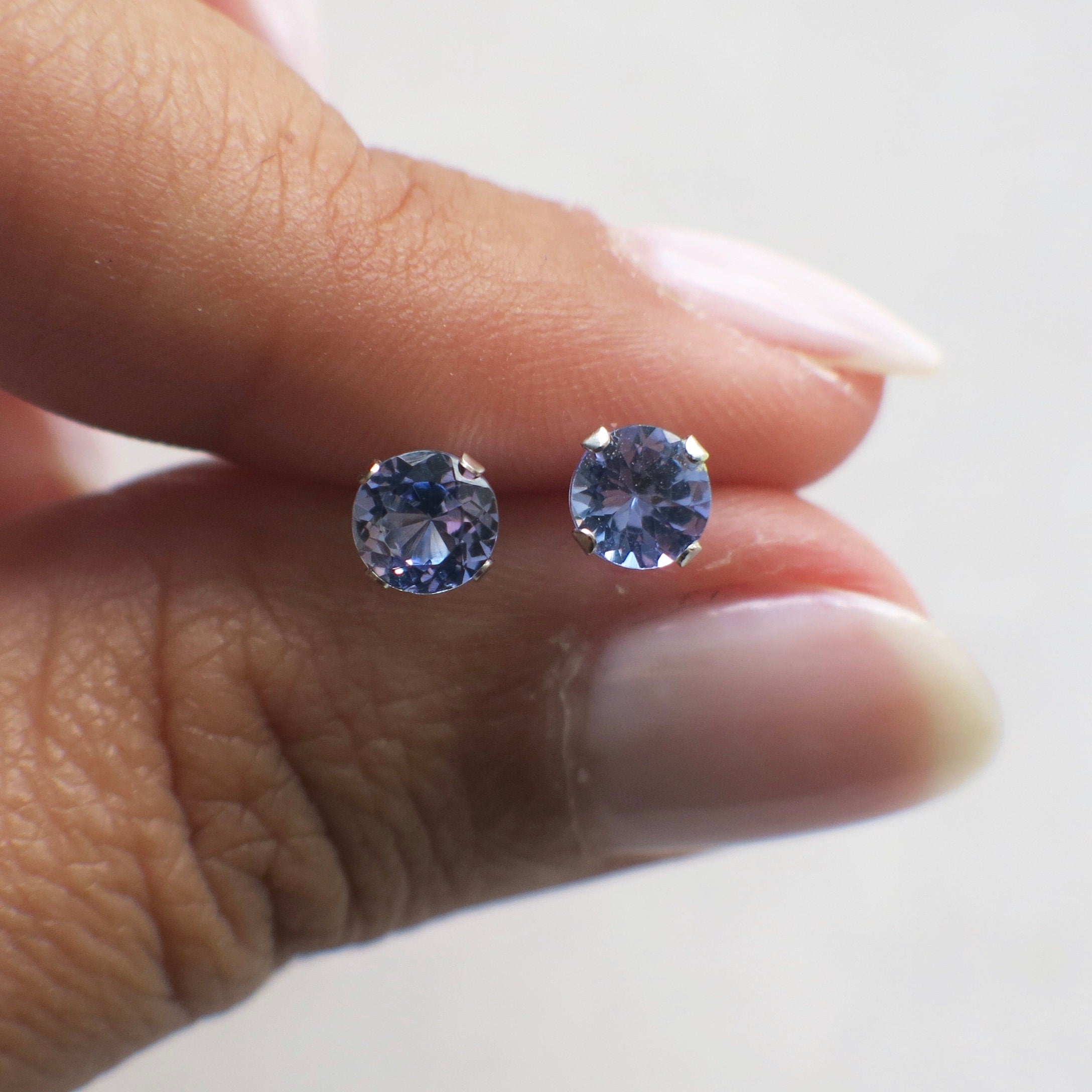 Tanzanite stud earrings in 14K white gold with 5mm round gemstones, elegant jewelry by Black Market LLC.