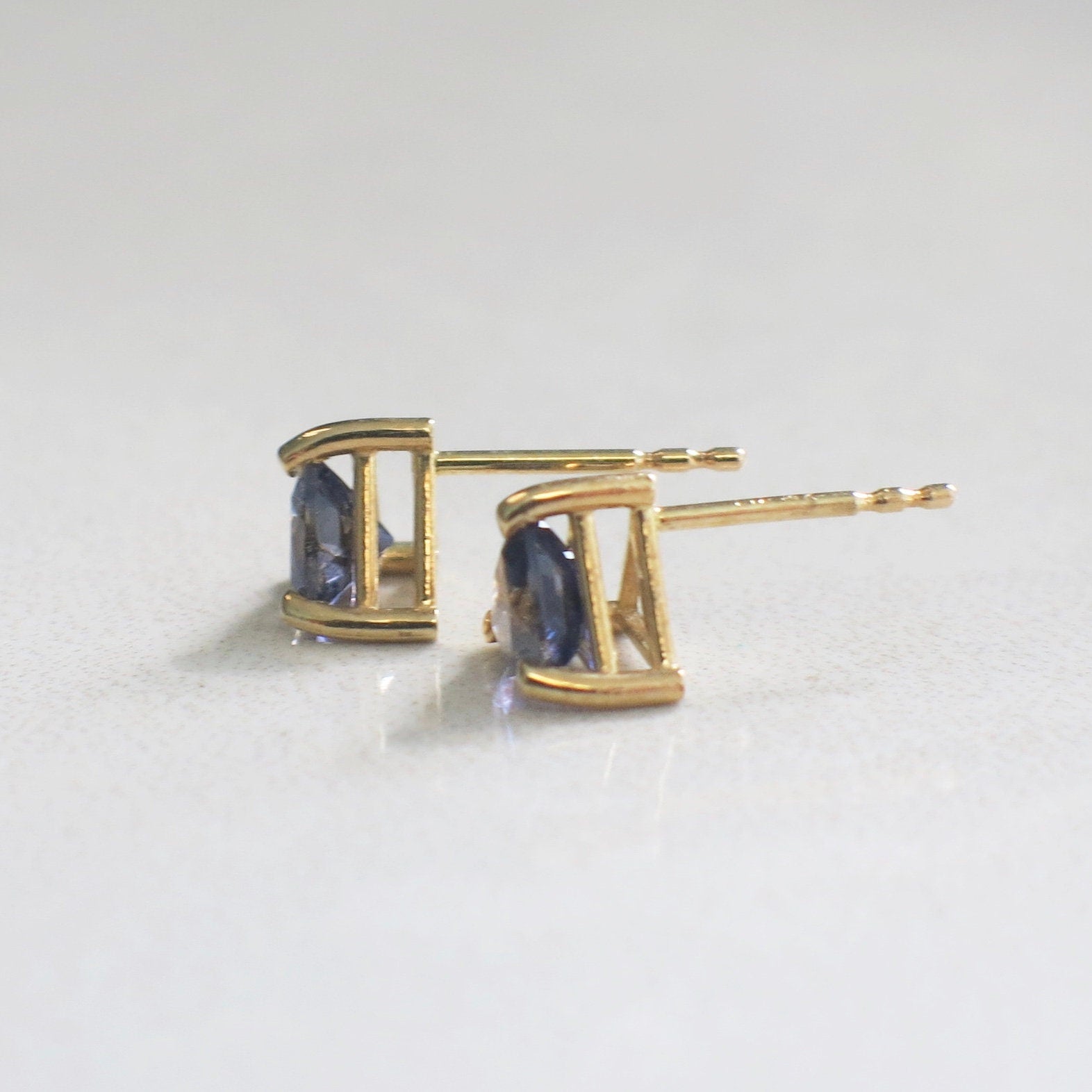 Trillion violet quartz stud earrings in 14K yellow gold with 5mm triangle cut gemstones, stylish and elegant jewelry.