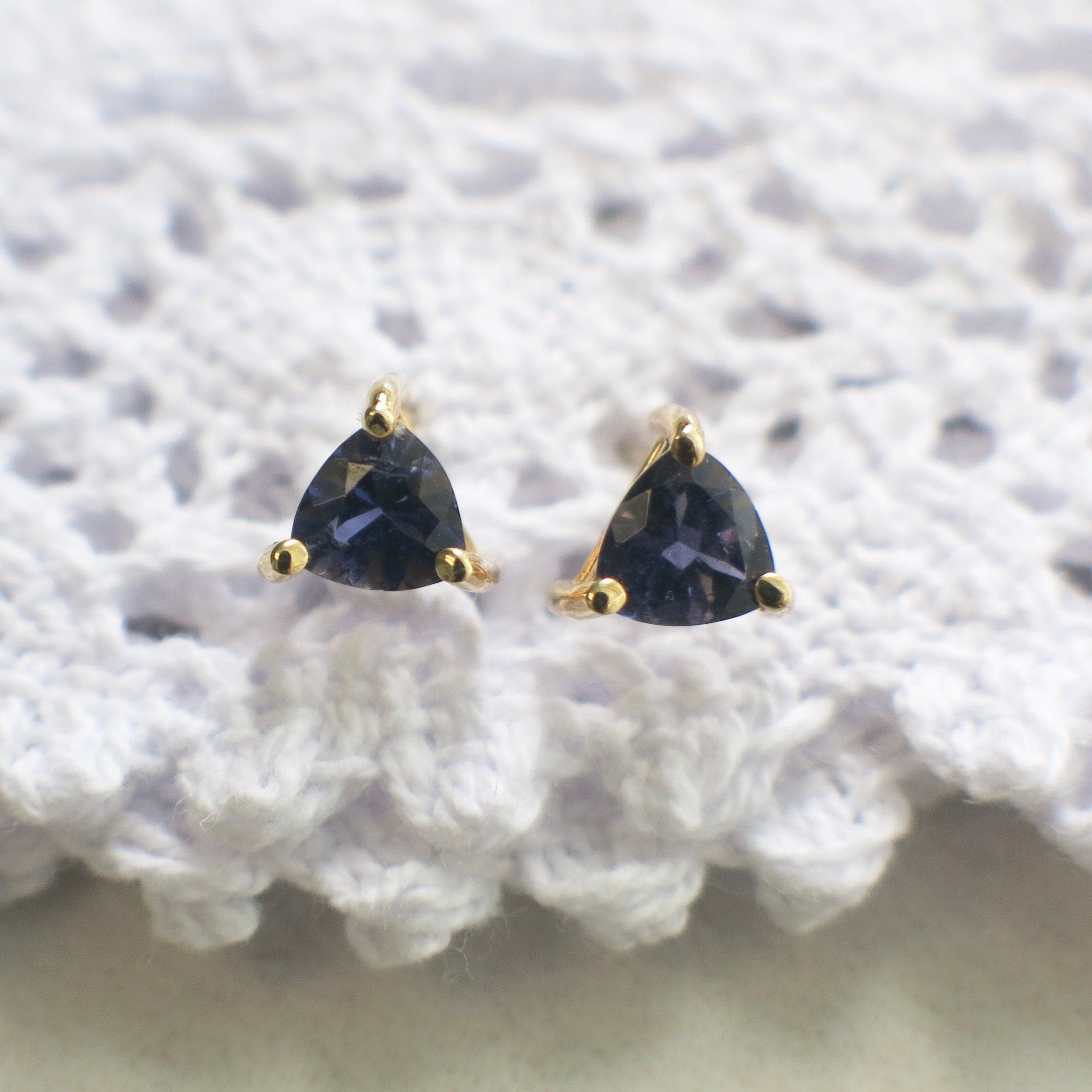 Trillion violet quartz stud earrings in 14K yellow gold with 5mm triangle cut, showcasing vibrant purple gemstones.