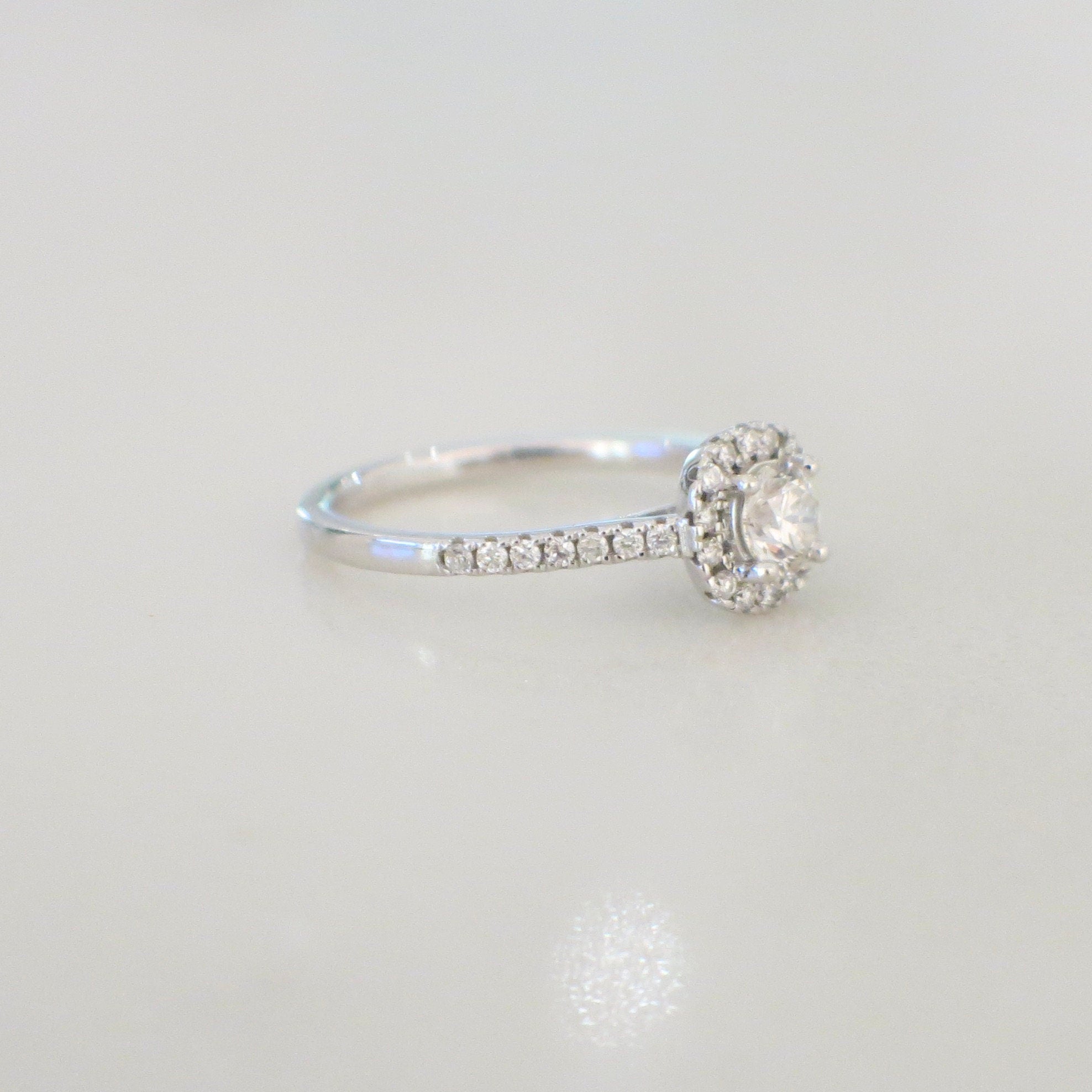 14K white gold diamond halo engagement ring with round brilliant center stone, petite bridal style, size 5.25, 0.58 CTW from Lillian James Bridal