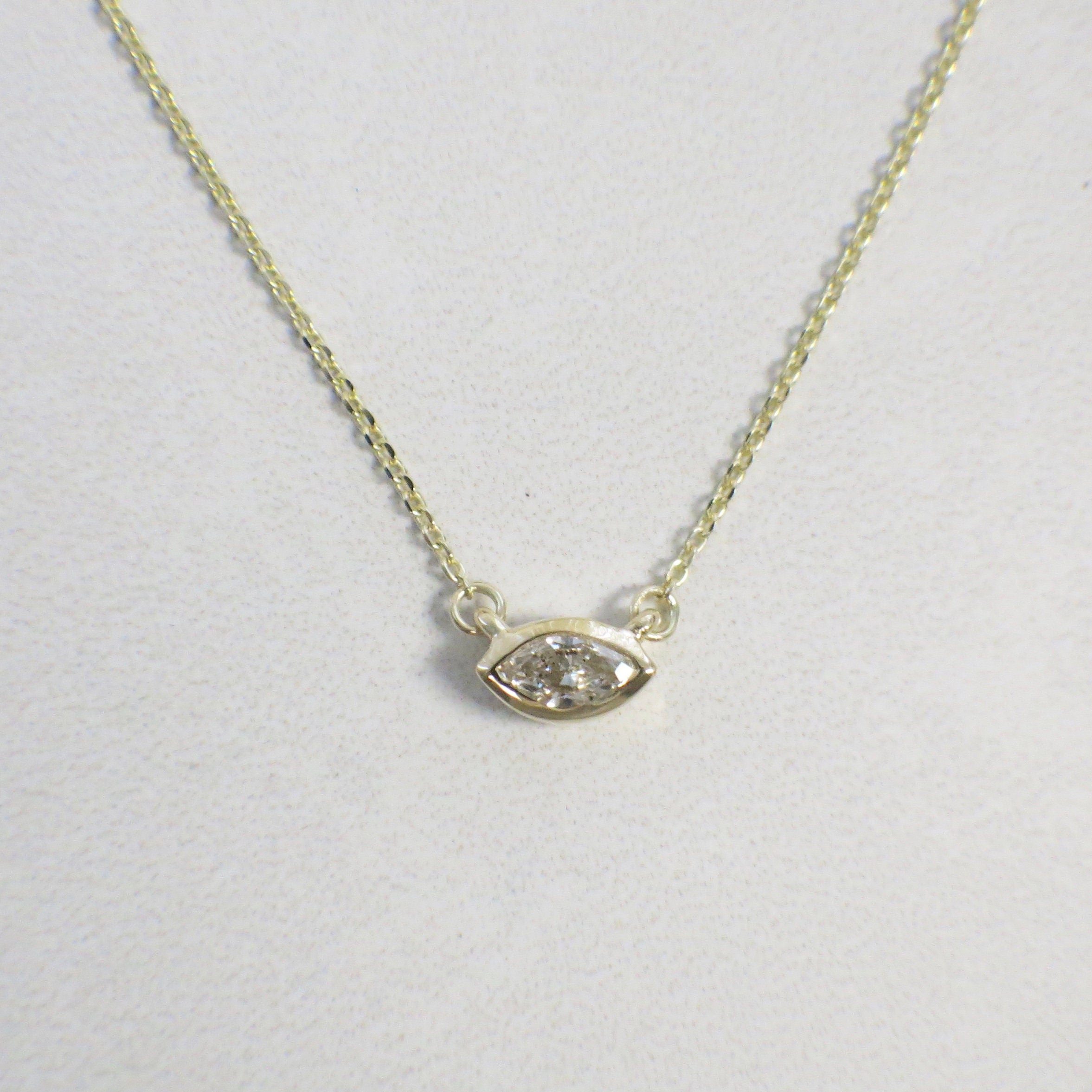 14K gold East-West Marquise diamond bezel necklace with solitaire pendant, featuring a white diamond on a sleek chain.