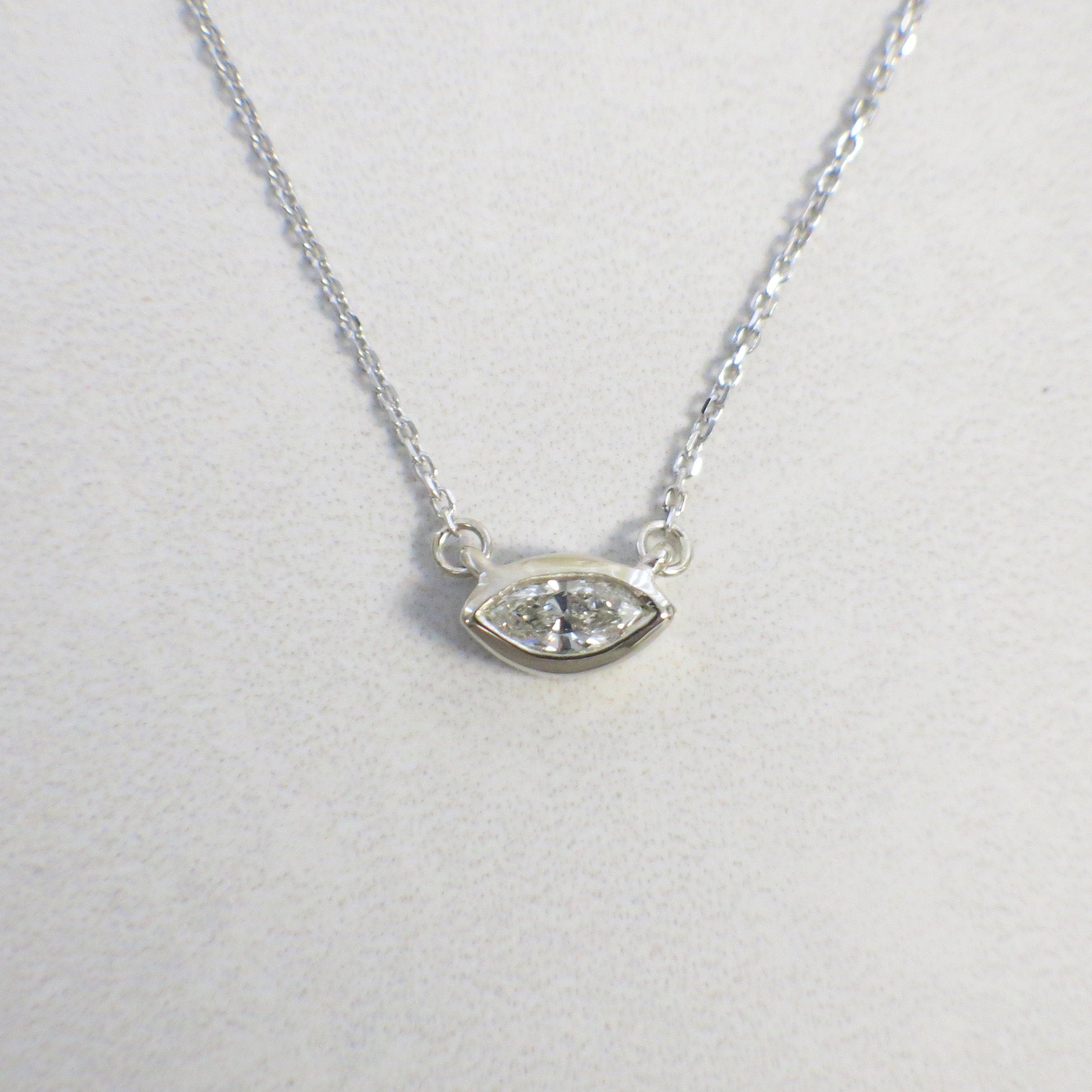 14K gold Marquise diamond bezel necklace with east-west solitaire pendant, featuring a white diamond on a sleek chain.