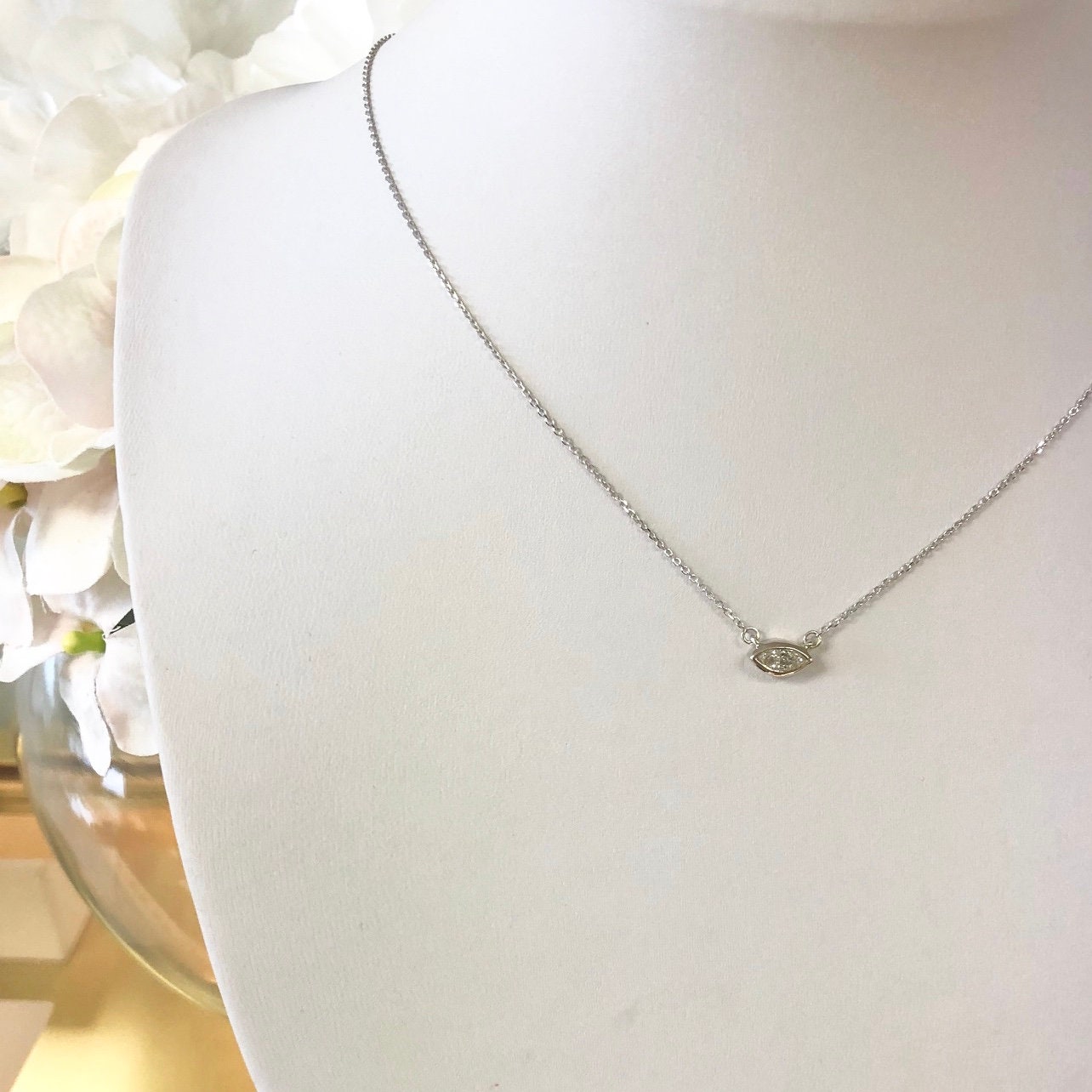 14K gold marquise diamond bezel necklace with east-west solitaire pendant, featuring a sleek and elegant design.