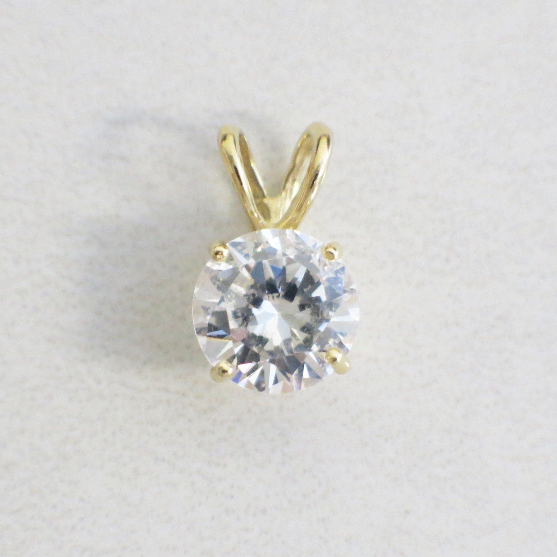 14K yellow gold round CZ solitaire pendant necklace with vintage 8mm charm, featuring a sparkling center stone and classic design.
