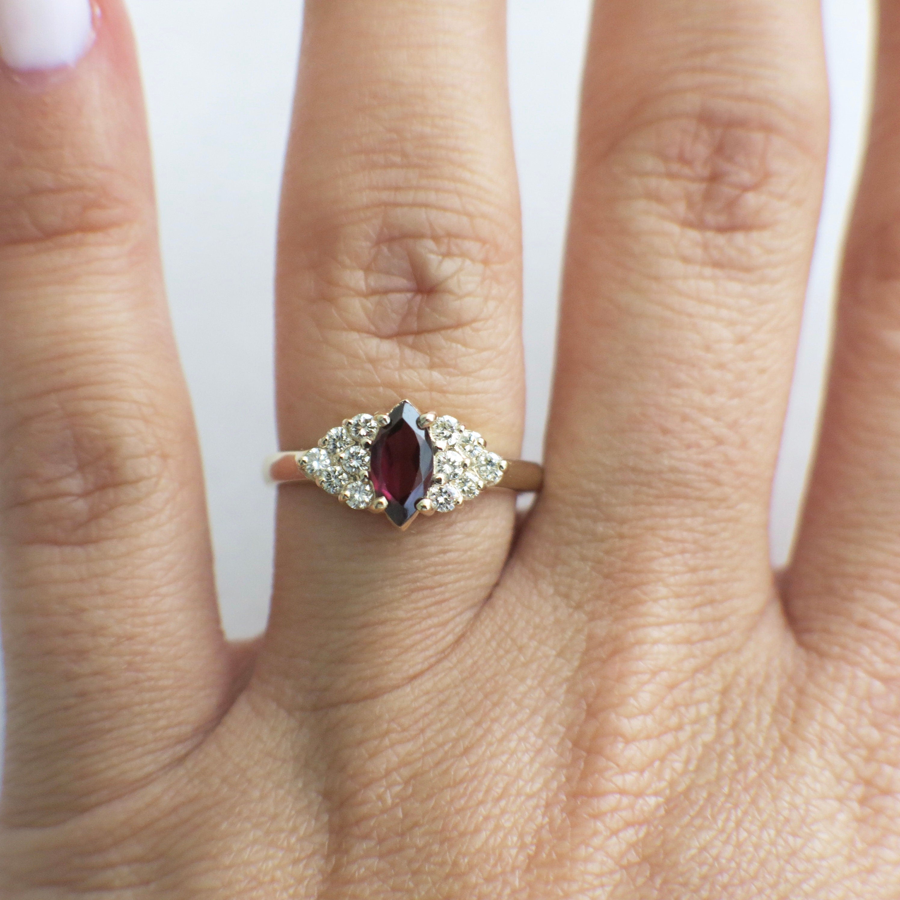 14K gold marquise garnet ring with diamond cluster accents, vintage style, size 6.5, featuring intricate gold detailing.