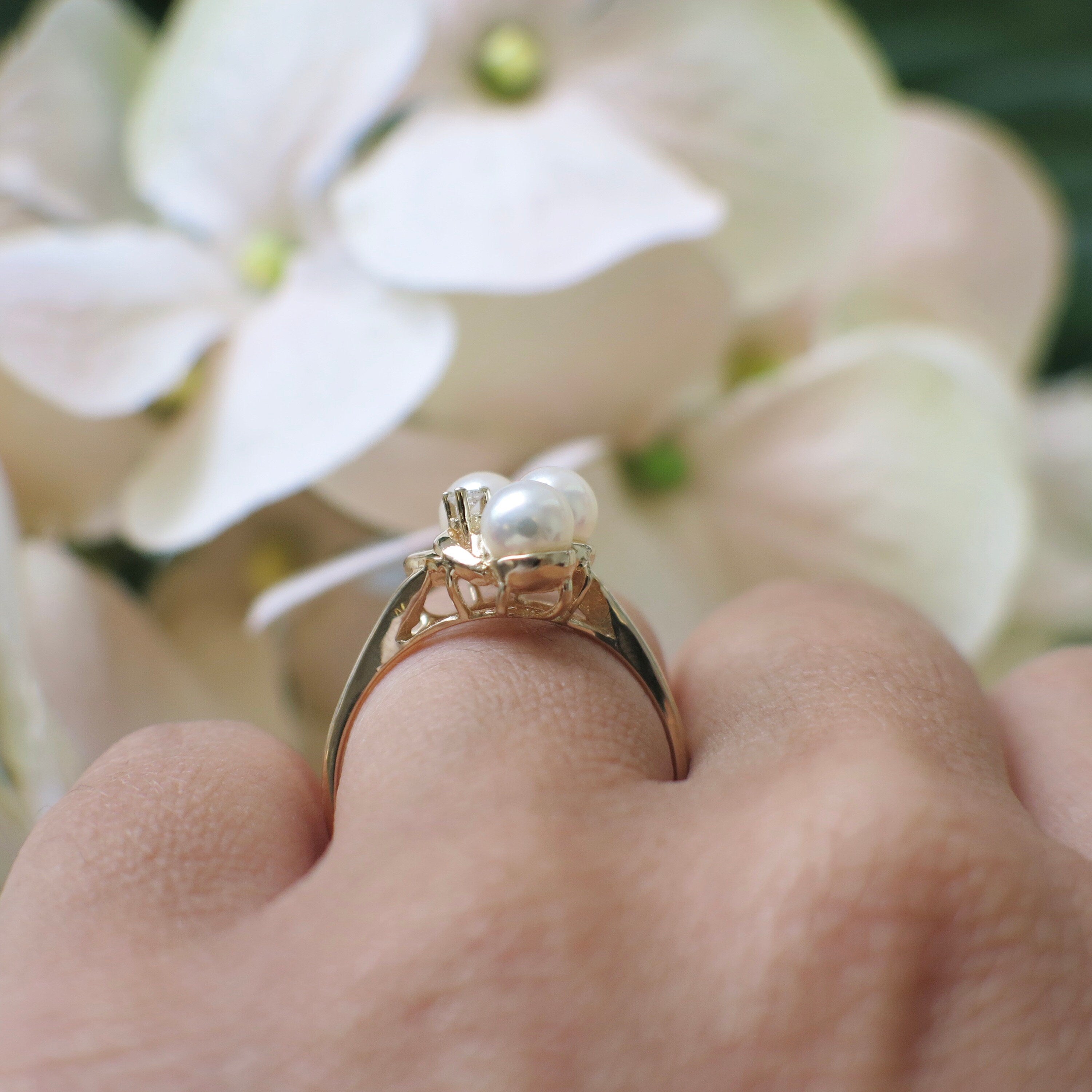 14K gold vintage ring with three pearls and diamonds, size 7.5, featuring elegant craftsmanship by Black Market LLC.