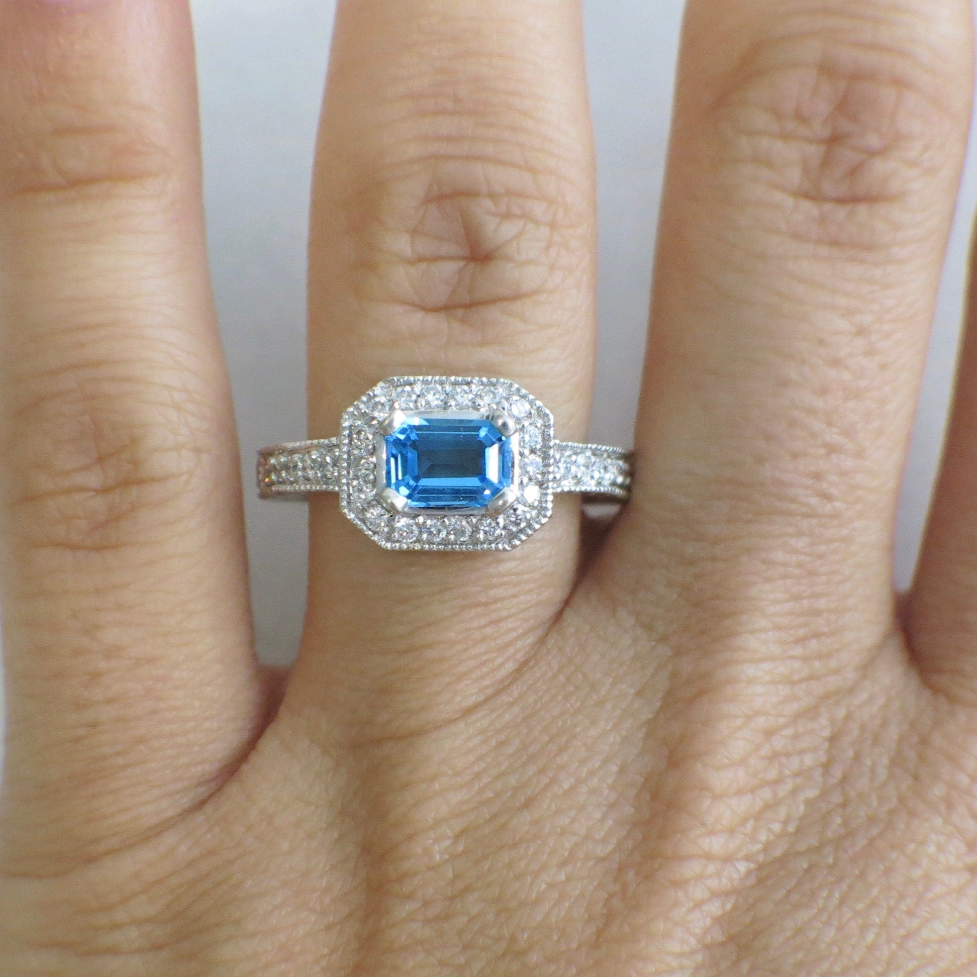 14K white gold Swiss Blue Topaz and diamond ring with east-west halo design, size 8.5, by Black Market LLC.