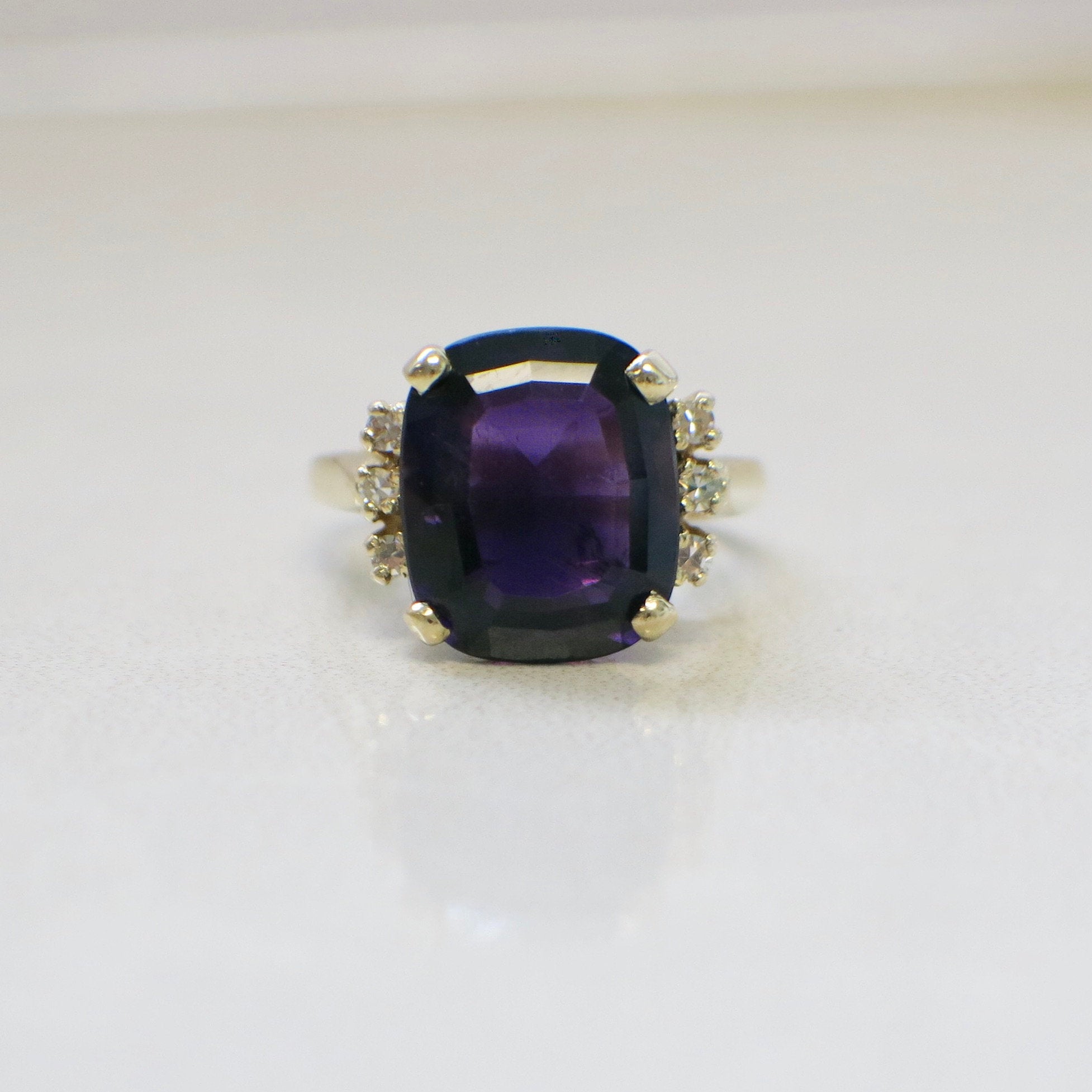 14K yellow gold cushion cut amethyst and diamond cocktail ring with intricate design, size 5.25, by Black Market LLC.