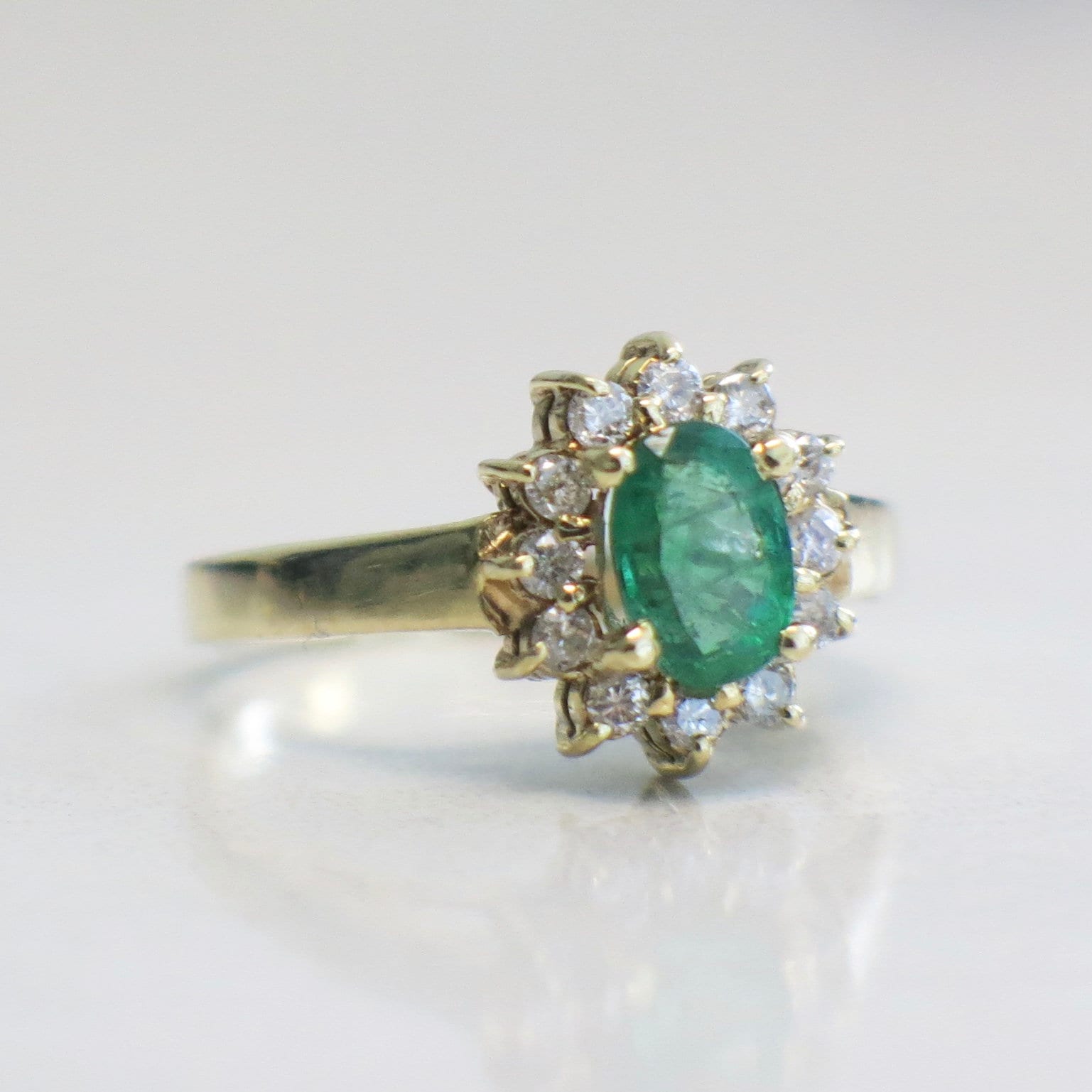 14K yellow gold emerald and diamond halo ring with oval May birthstone, size 3.75, featuring intricate design and sparkling gemstones