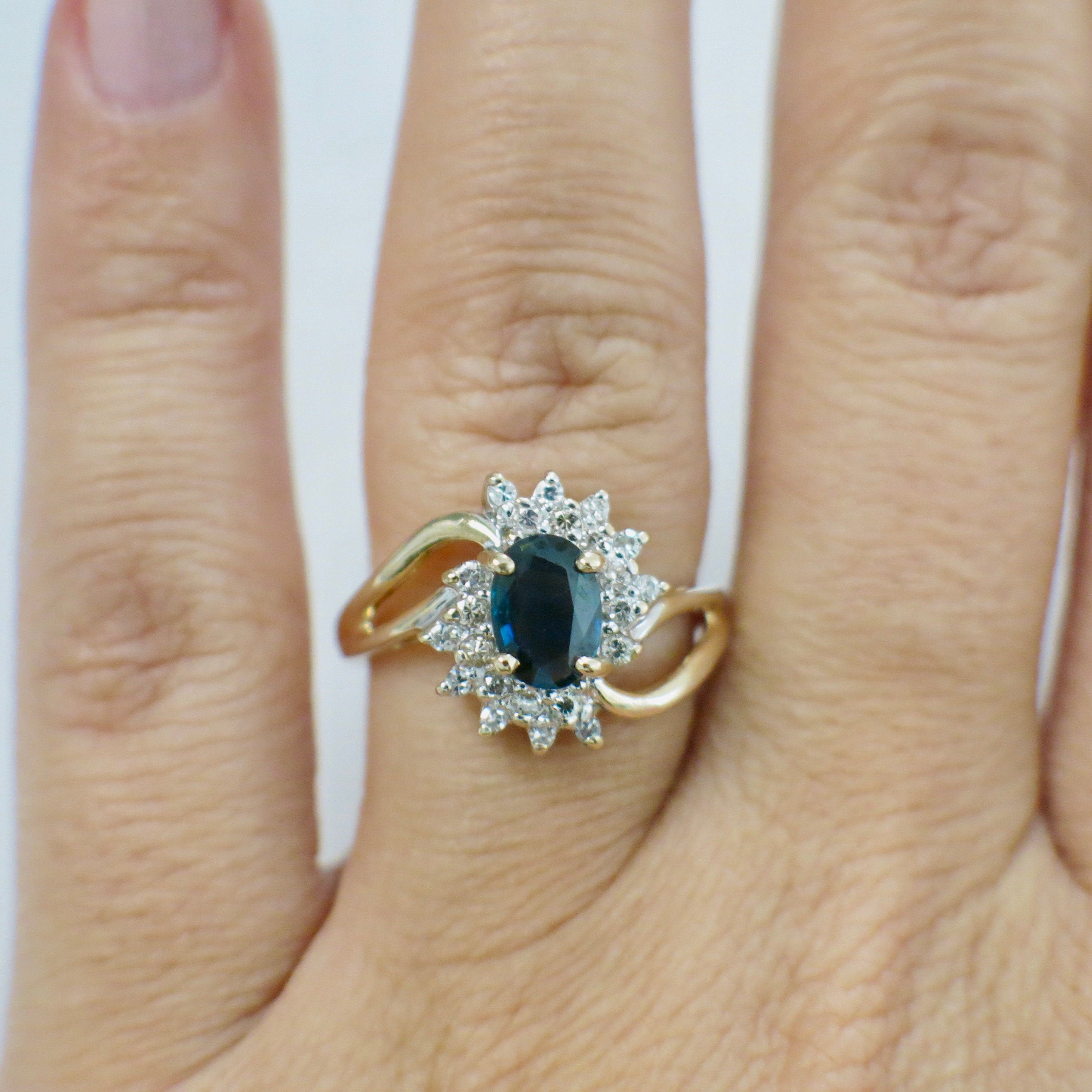 14K yellow gold oval sapphire and diamond halo ring with split shank, size 6.5, by Black Market LLC.