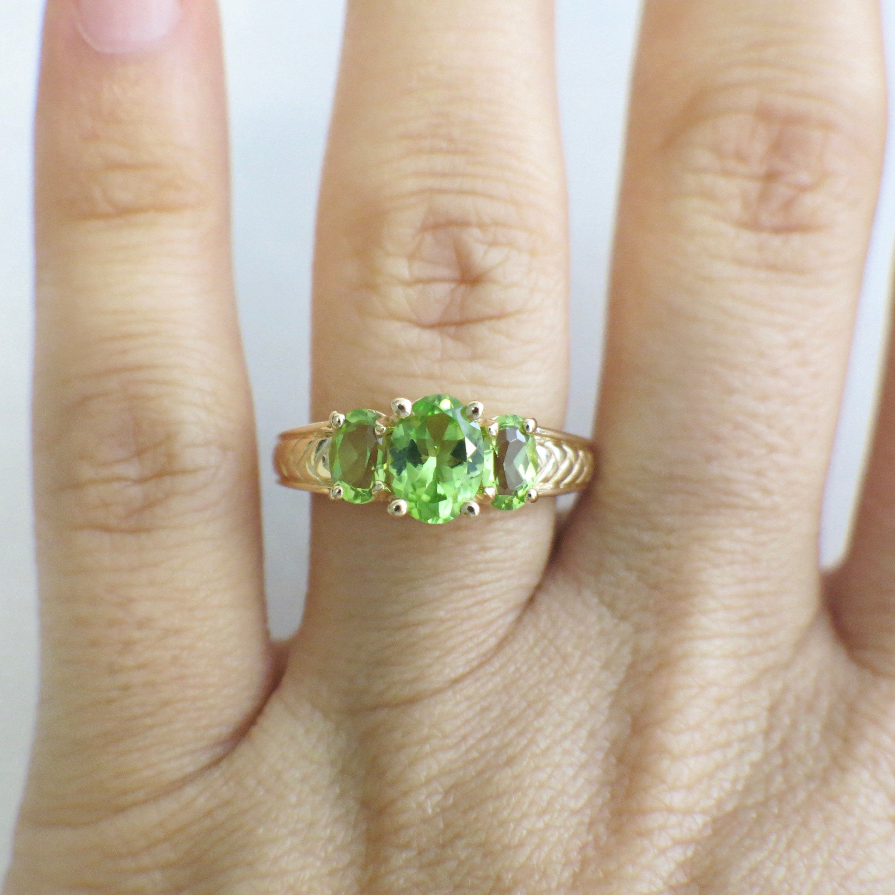 14K yellow gold Peridot three-stone ring with oval-cut stones, size 7, featuring August birthstone, by Black Market LLC.