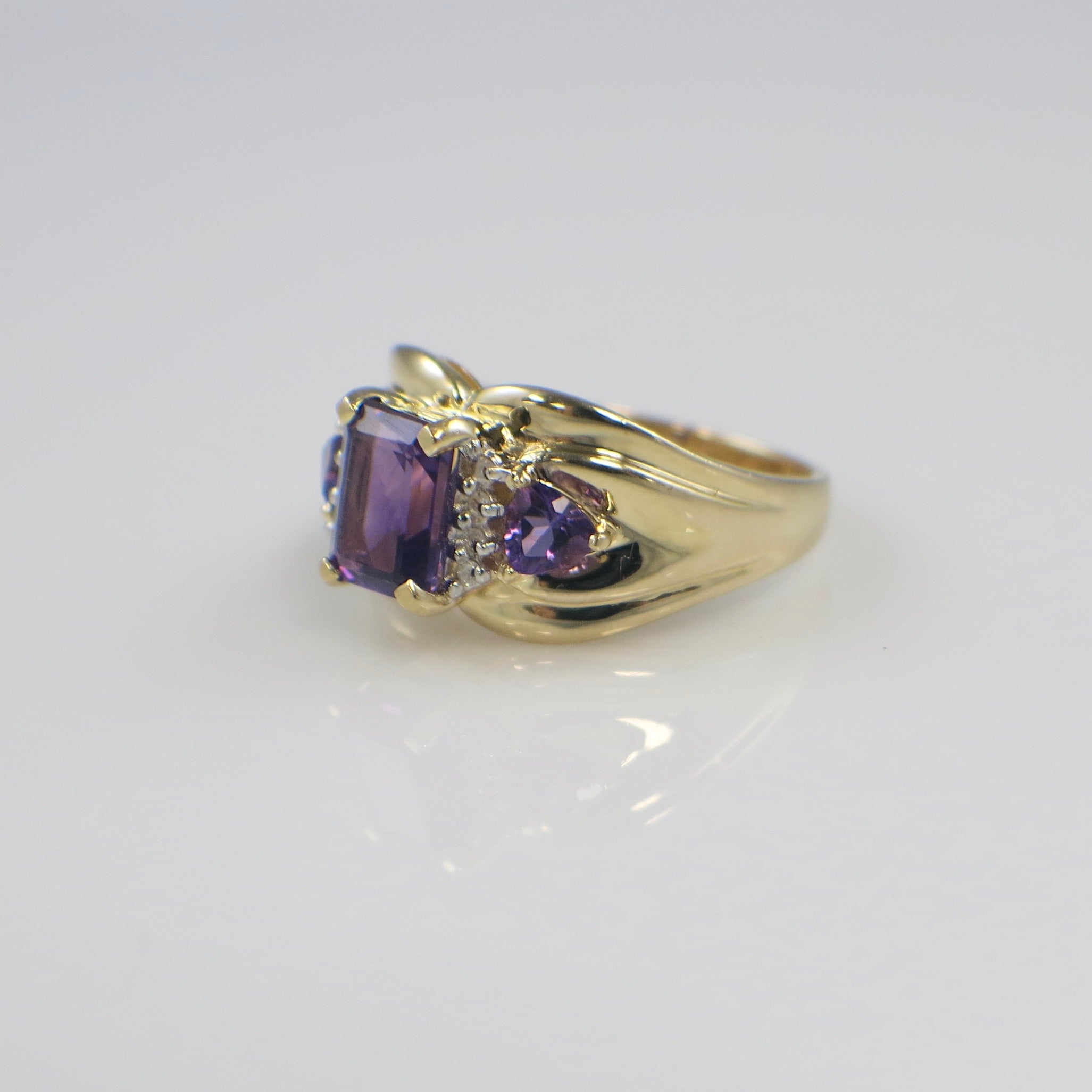 14K yellow gold Town and Country amethyst and diamond ring with emerald cut center stone and trillion side stones, size 8.5