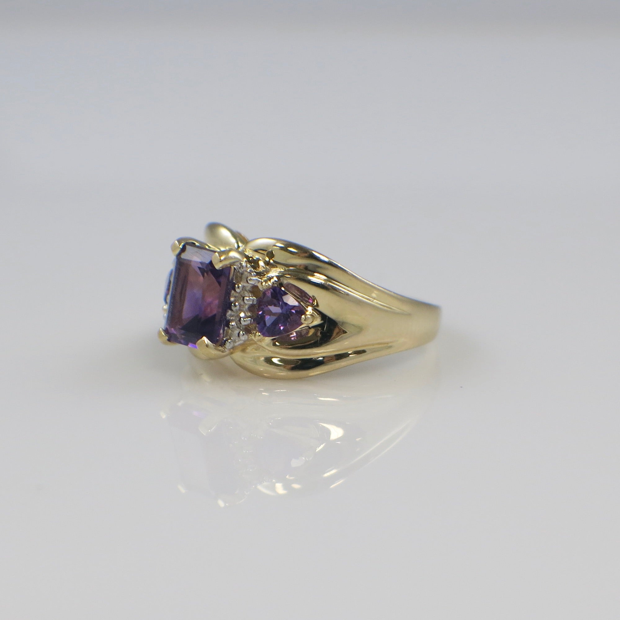 14K yellow gold Town and Country amethyst and diamond ring with emerald cut center stone and trillion side stones, size 8.5.