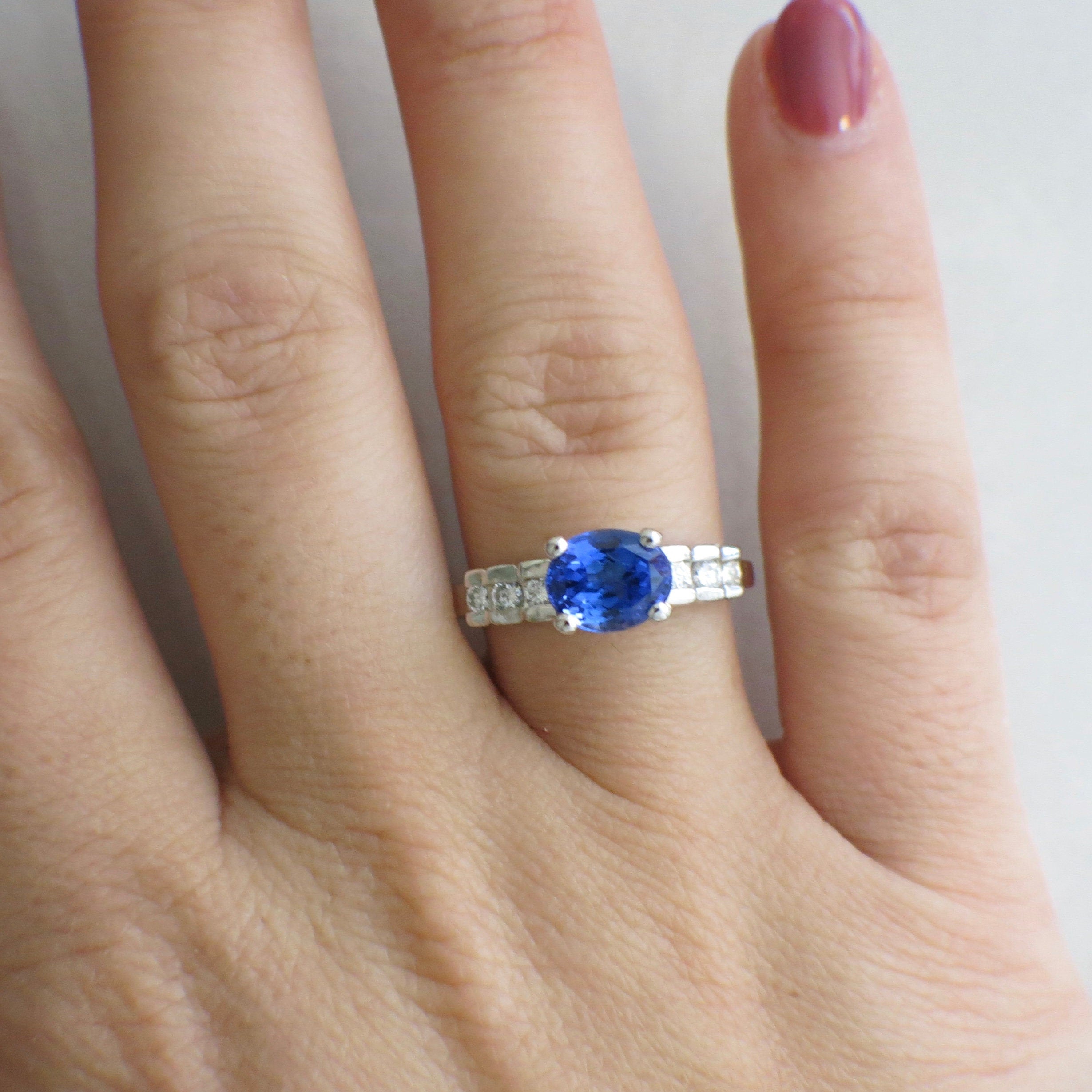 18K white gold oval tanzanite and diamond ring with east-to-west setting, size 8.5, by Black Market LLC.
