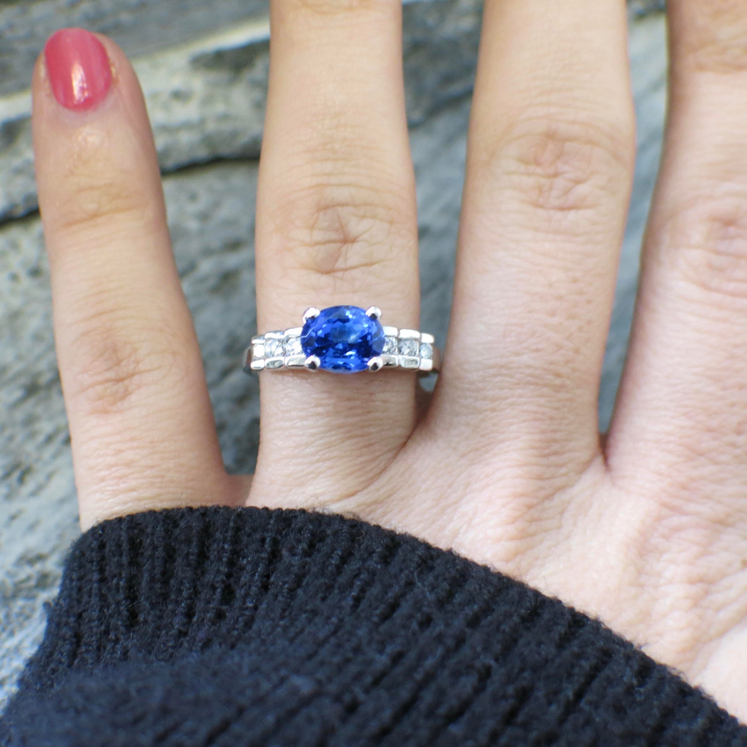 18K white gold oval tanzanite and diamond ring with east-to-west setting, size 8.5, by Black Market LLC.