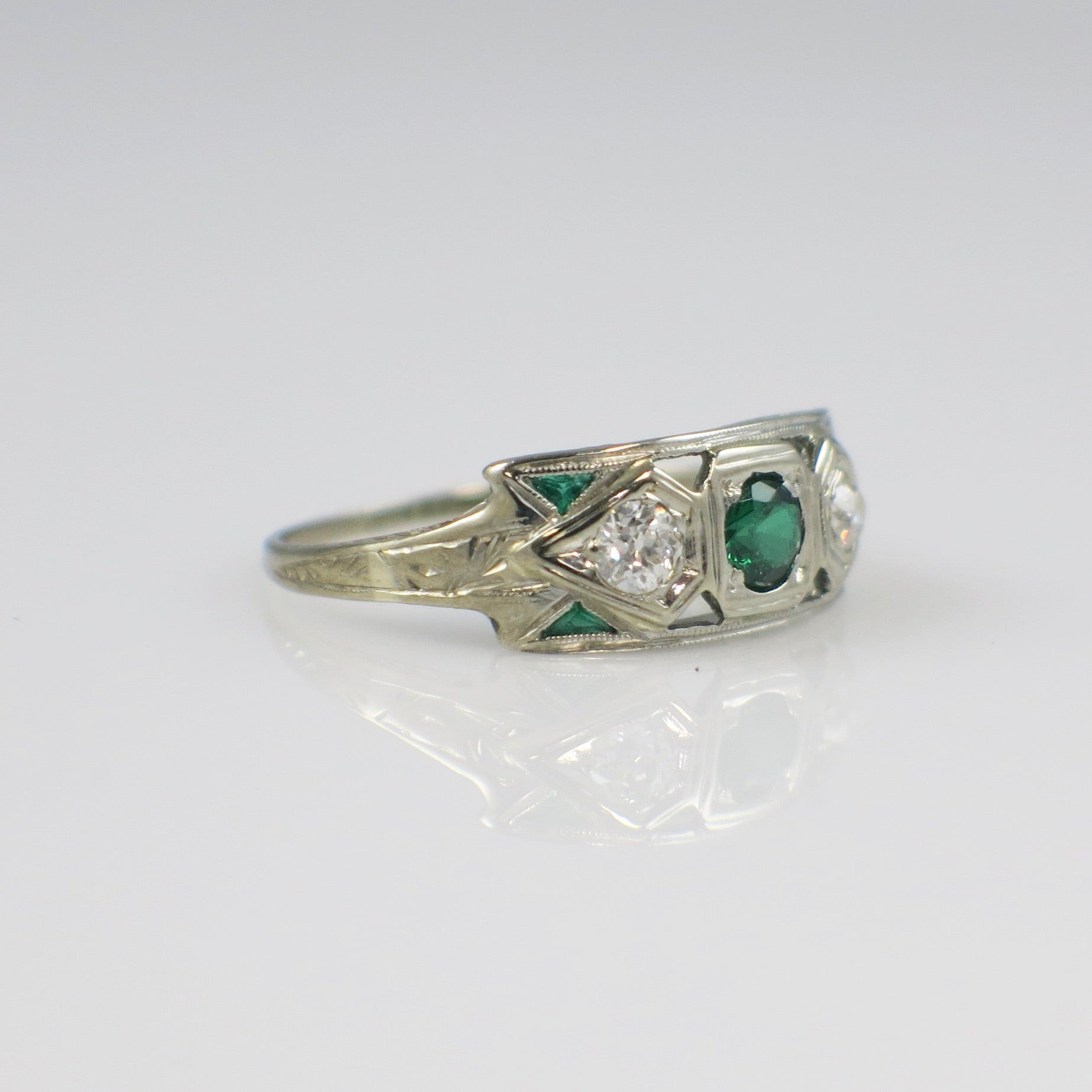 Vintage 14K white gold Art Deco ring with tsavorite garnet and old European cut diamonds, showcasing intricate design details.
