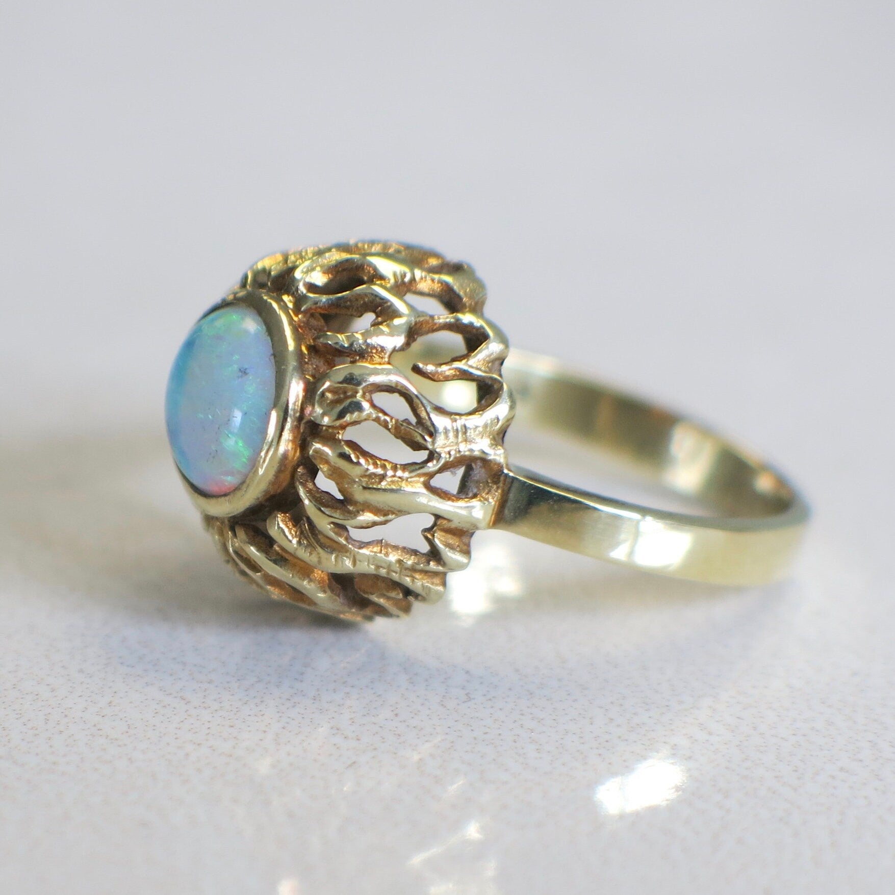 Vintage 14K yellow gold opal ring by Black Market LLC featuring a bezel-set round cabochon October birthstone.