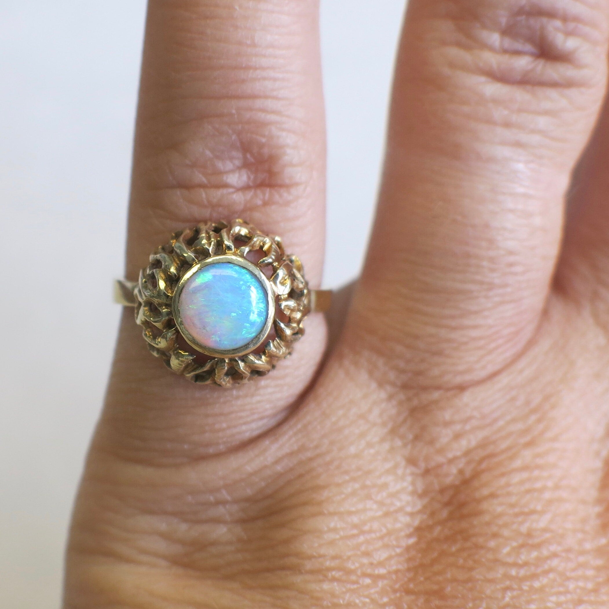 Vintage 14K yellow gold opal ring with bezel-set round cabochon, October birthstone, by Black Market LLC.