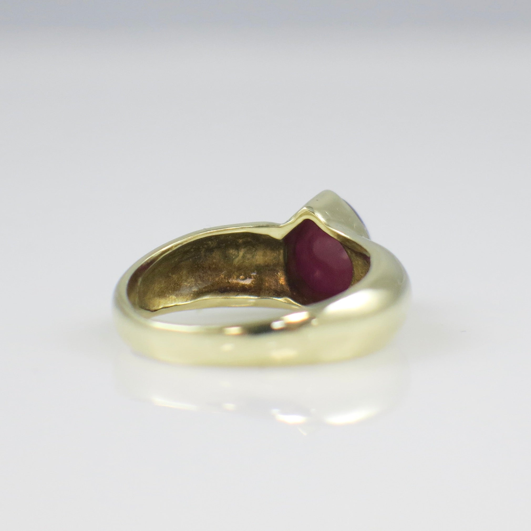 Vintage 14K yellow gold ring featuring a pear-shaped cabochon ruby bezel setting, bold gemstone jewelry design by Black Market LLC.