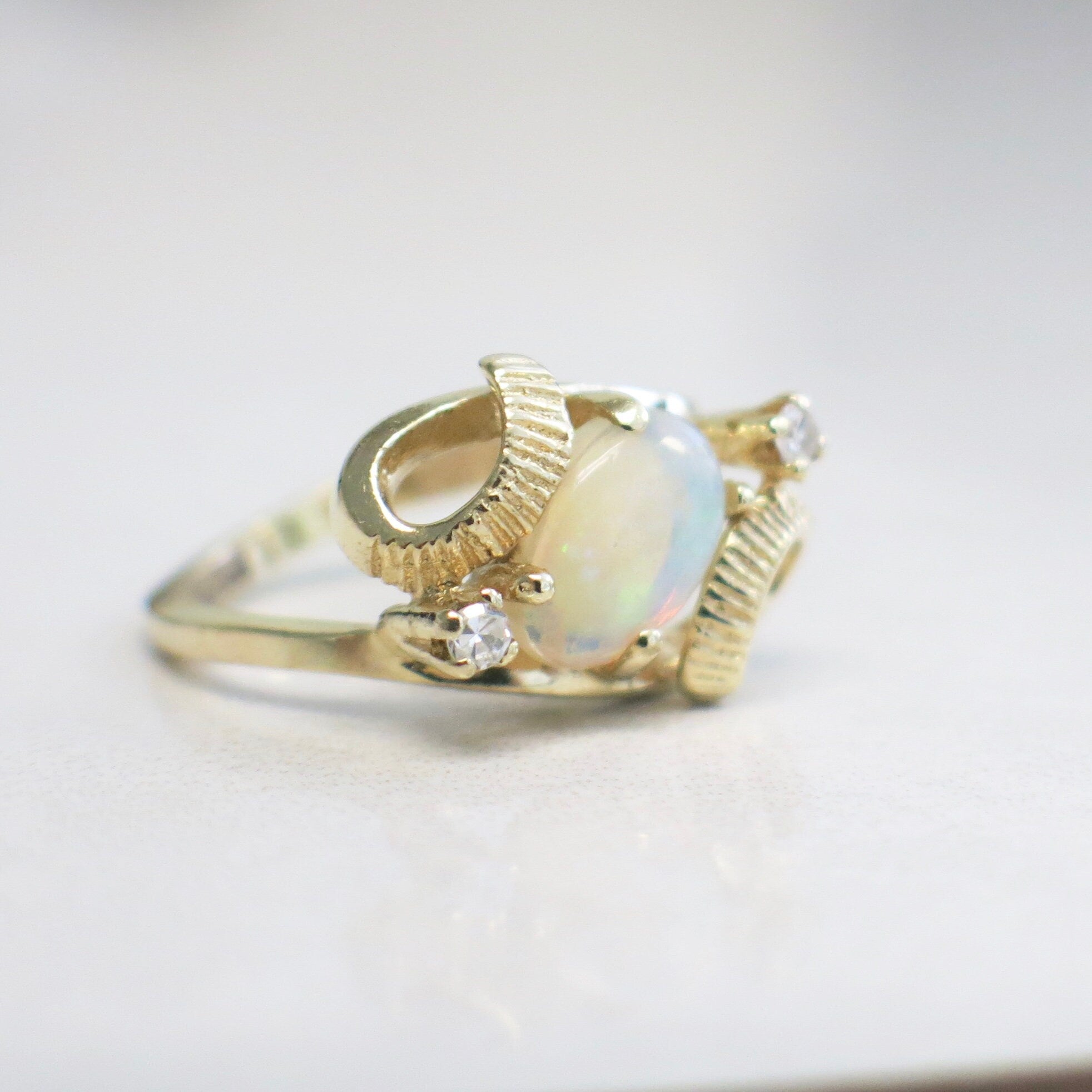 Vintage 14K yellow gold white opal and diamond ring with oval opal and European shank, size 4, by Black Market LLC.