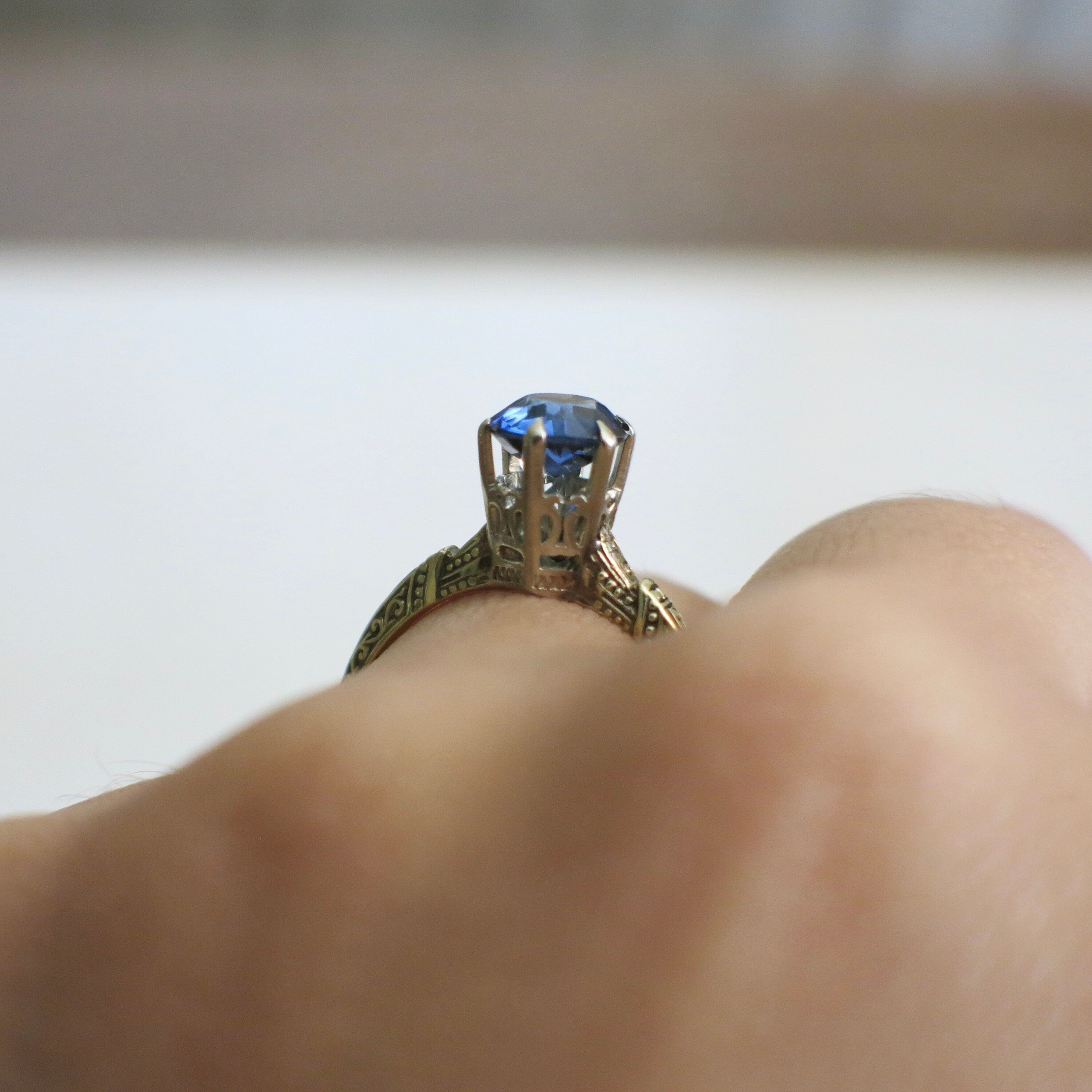 Vintage sapphire blue glass ring with 14K two-tone gold filigree crown setting, size 6.75, by Black Market LLC.