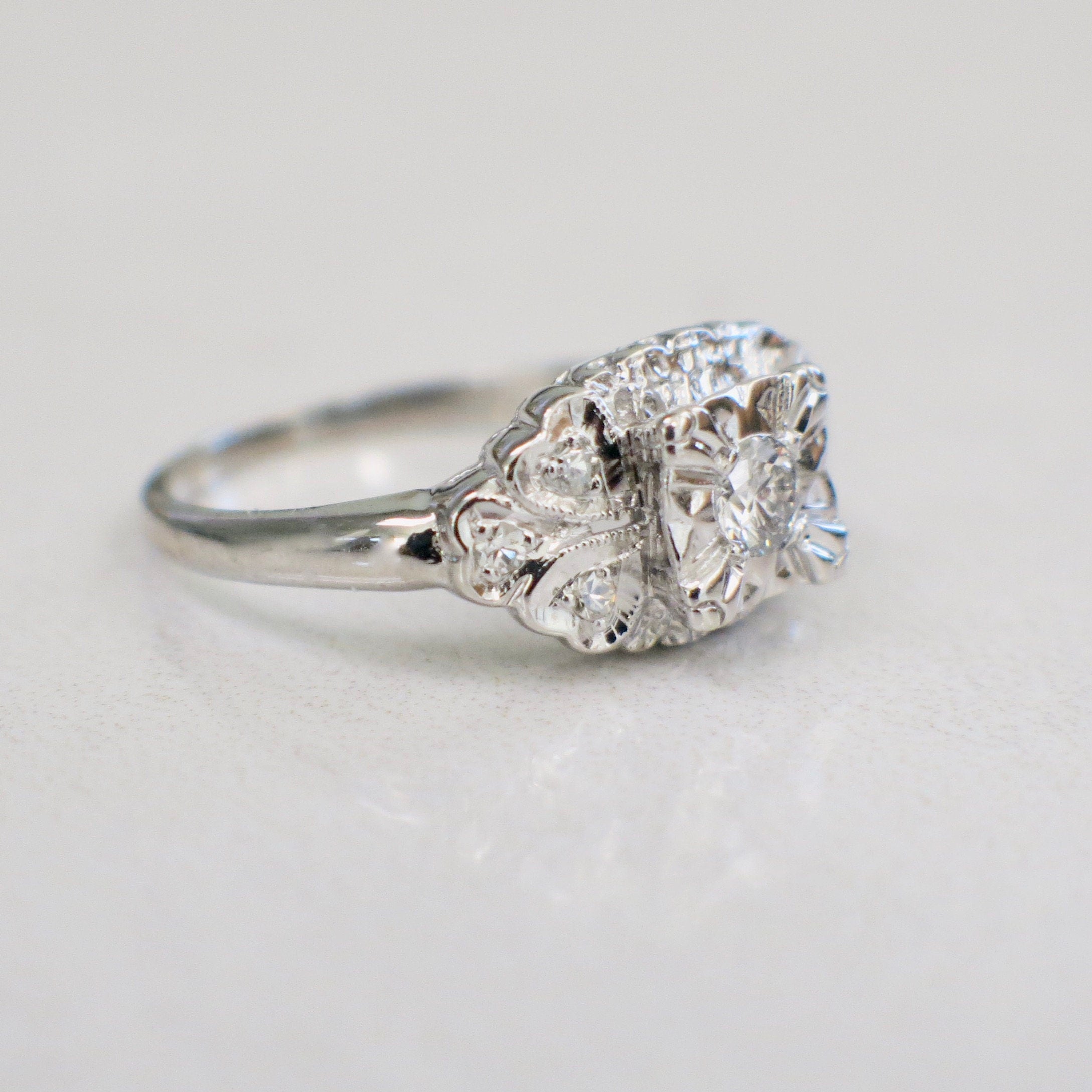 Vintage 14K white gold diamond engagement ring with milgrain detail, size 5.75, from Black Market LLC.