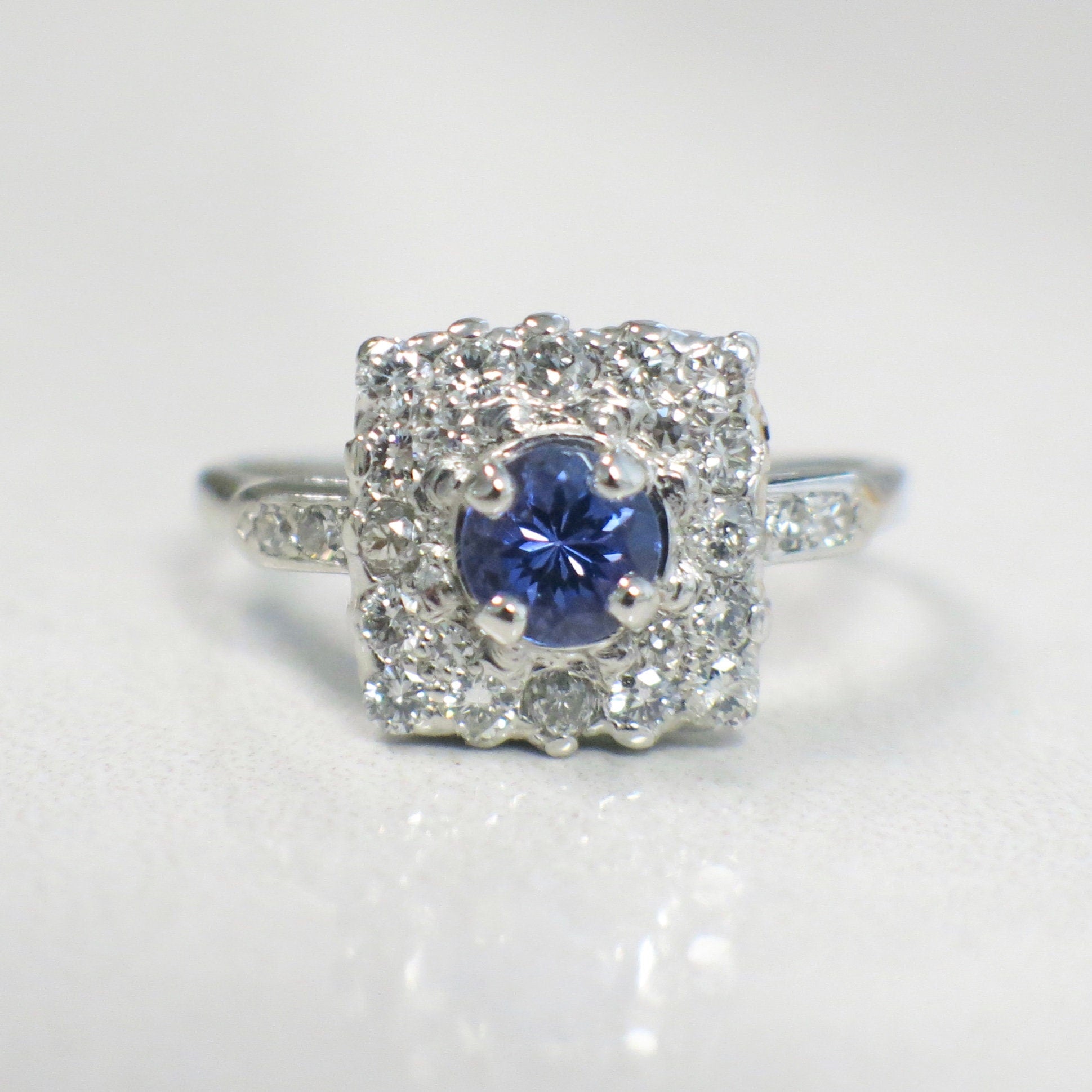Vintage platinum tanzanite and diamond halo ring with square cluster design, 0.56 CTW diamonds, size 6.75, by Black Market LLC.