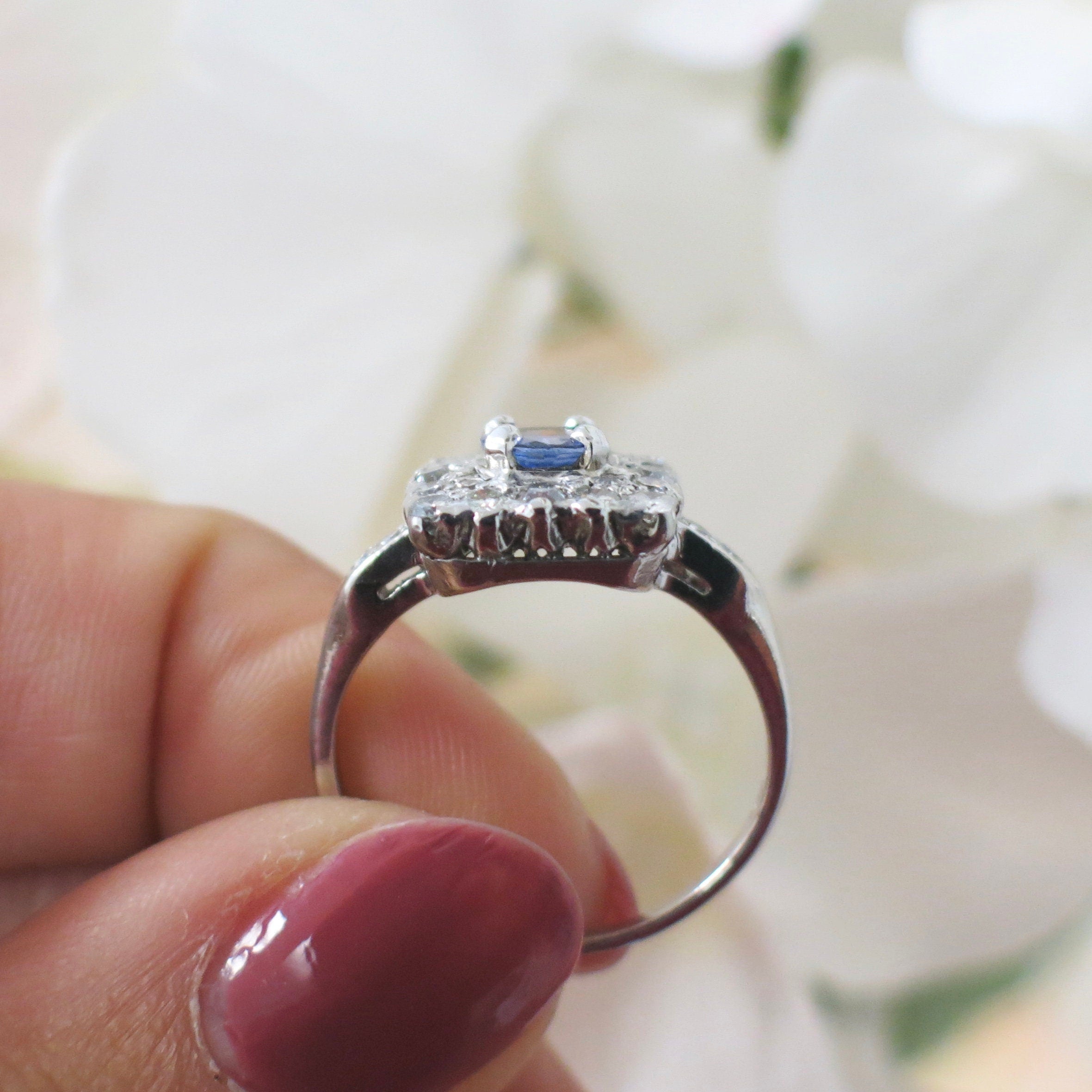 Vintage platinum tanzanite and diamond halo ring with square cluster design, 0.56 CTW diamonds, size 6.75, from Black Market LLC.