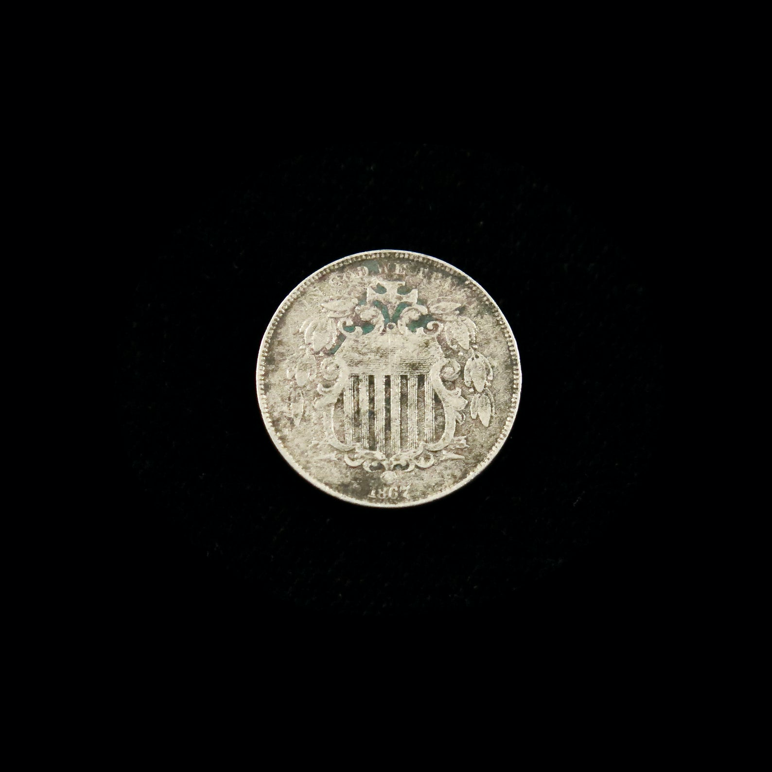 1867 Shield Nickel no rays, good condition, raw U.S. five-cent coin, Black Market LLC nickel collectible.
