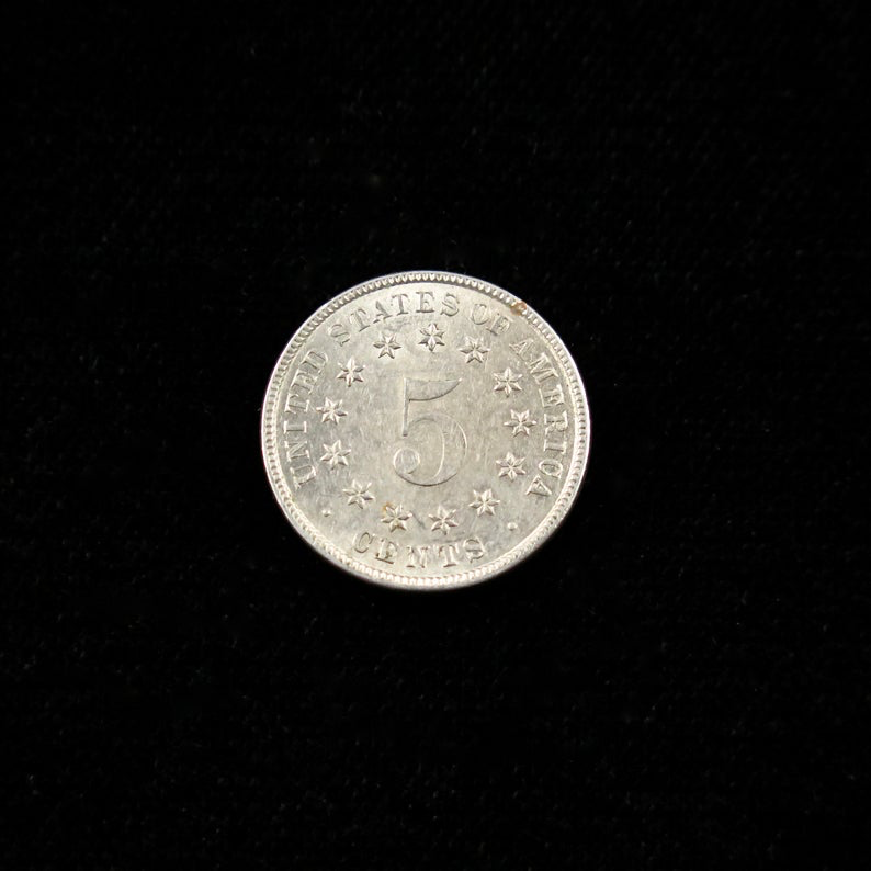 Mint state 1883 Shield Nickel, final year U.S. five-cent coin, raw condition, showcasing its detailed shield design.
